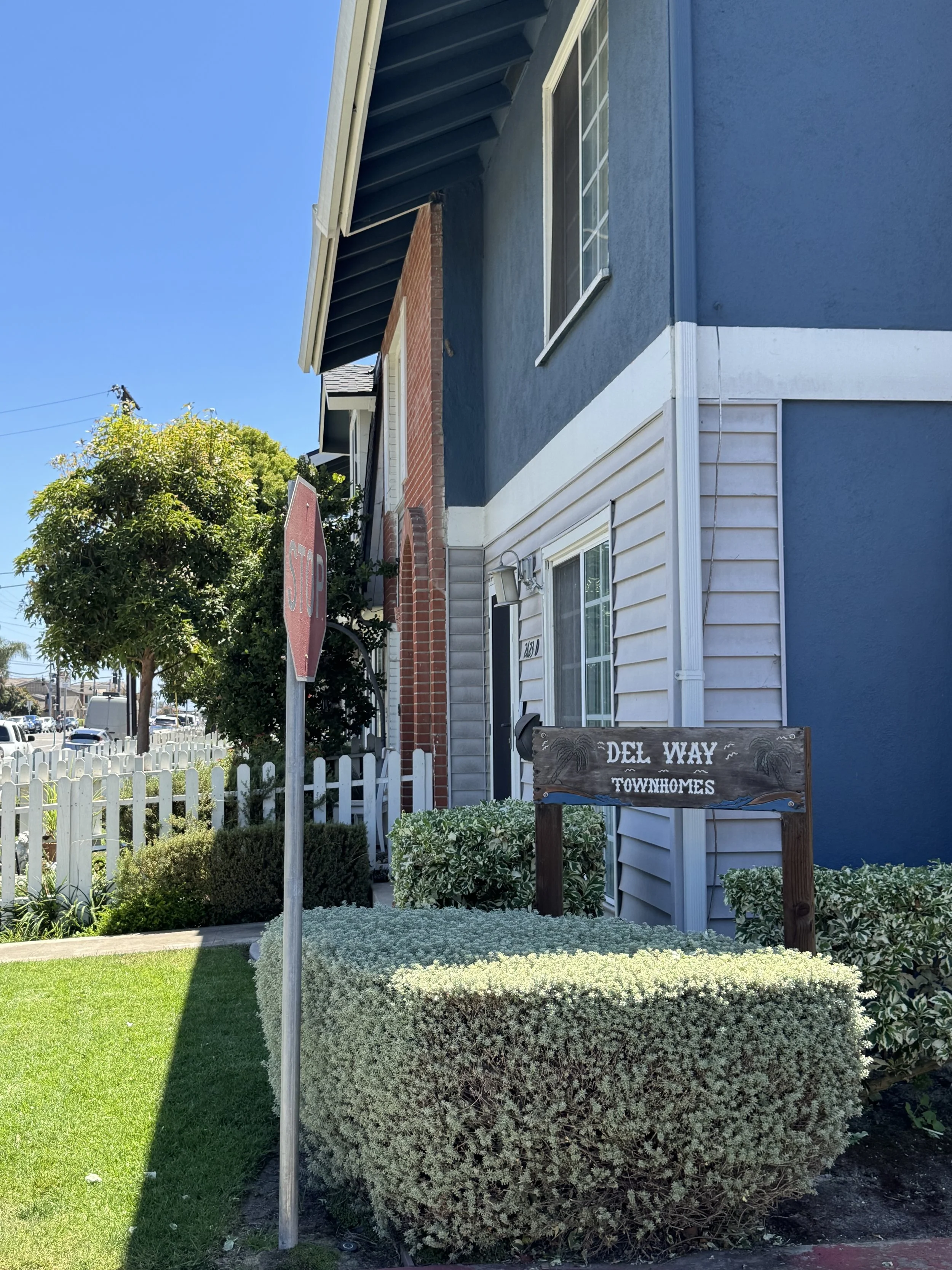Del Way townhomes for sale in Huntington Beach featuring the community entrance sign placard.