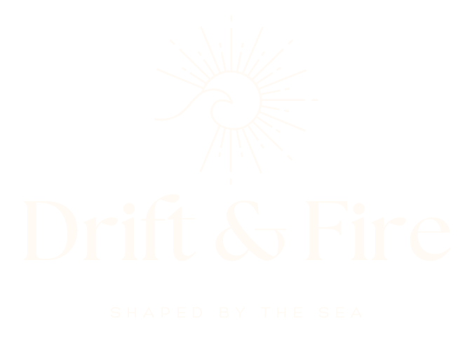 Logo with a stylized wave inside a circular burst and the text "Drift & Fire" with the tagline "Shaped by the Sea".