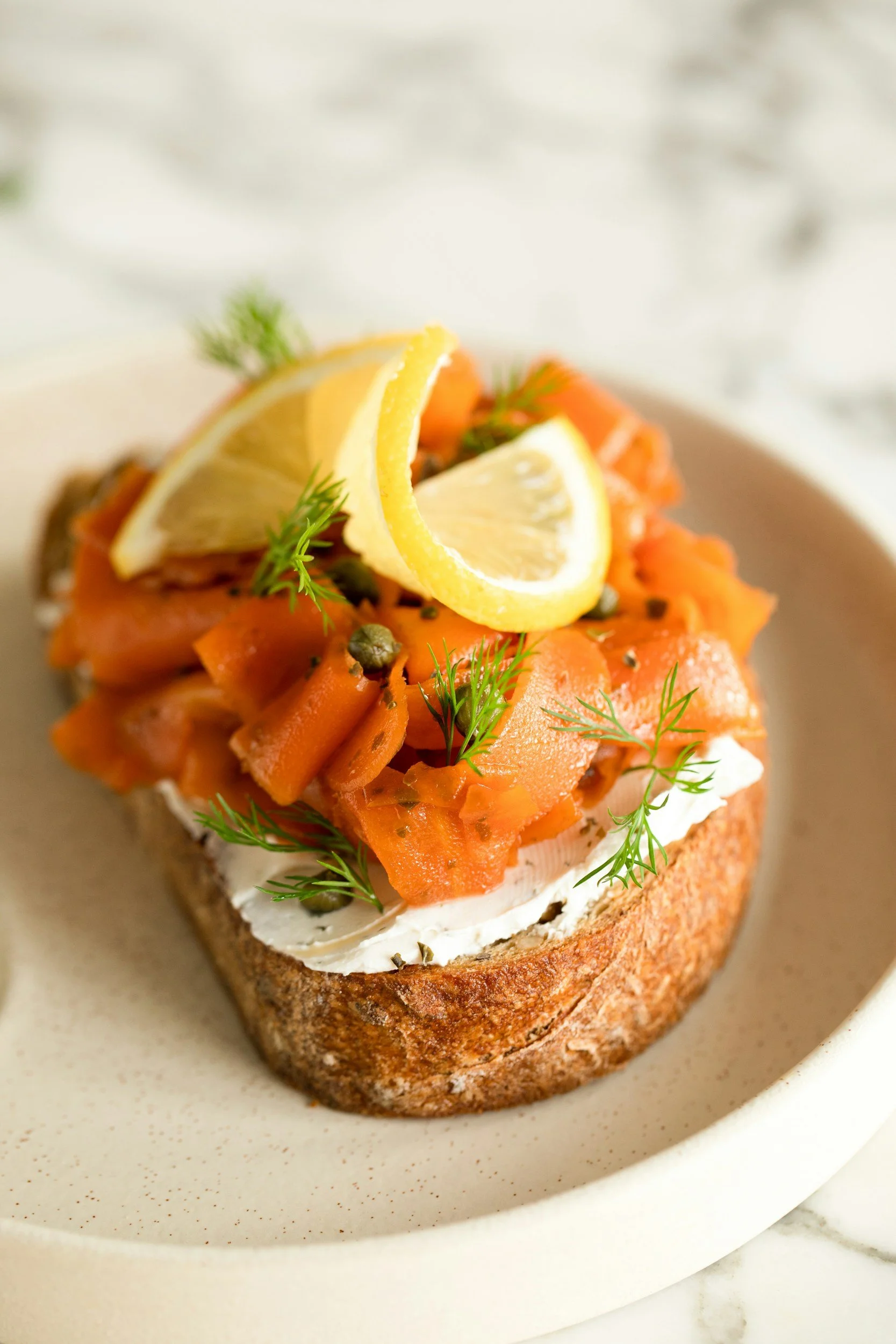 Gourmet breakfast catering featuring fresh avocado and smoked salmon toast served on a private cruise.