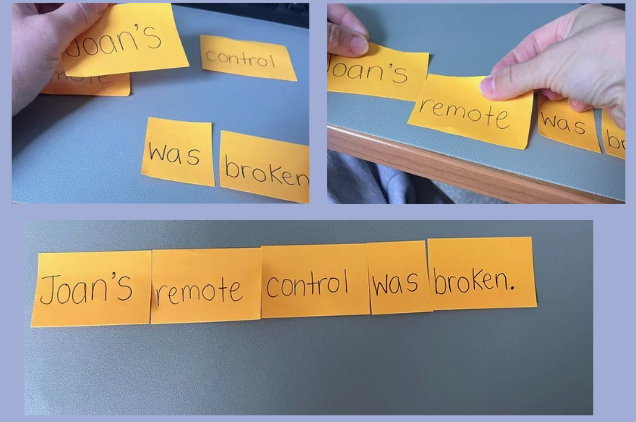 Orange sticky notes arranged on a blue surface forming the sentence: "Joan's remote control was broken."
