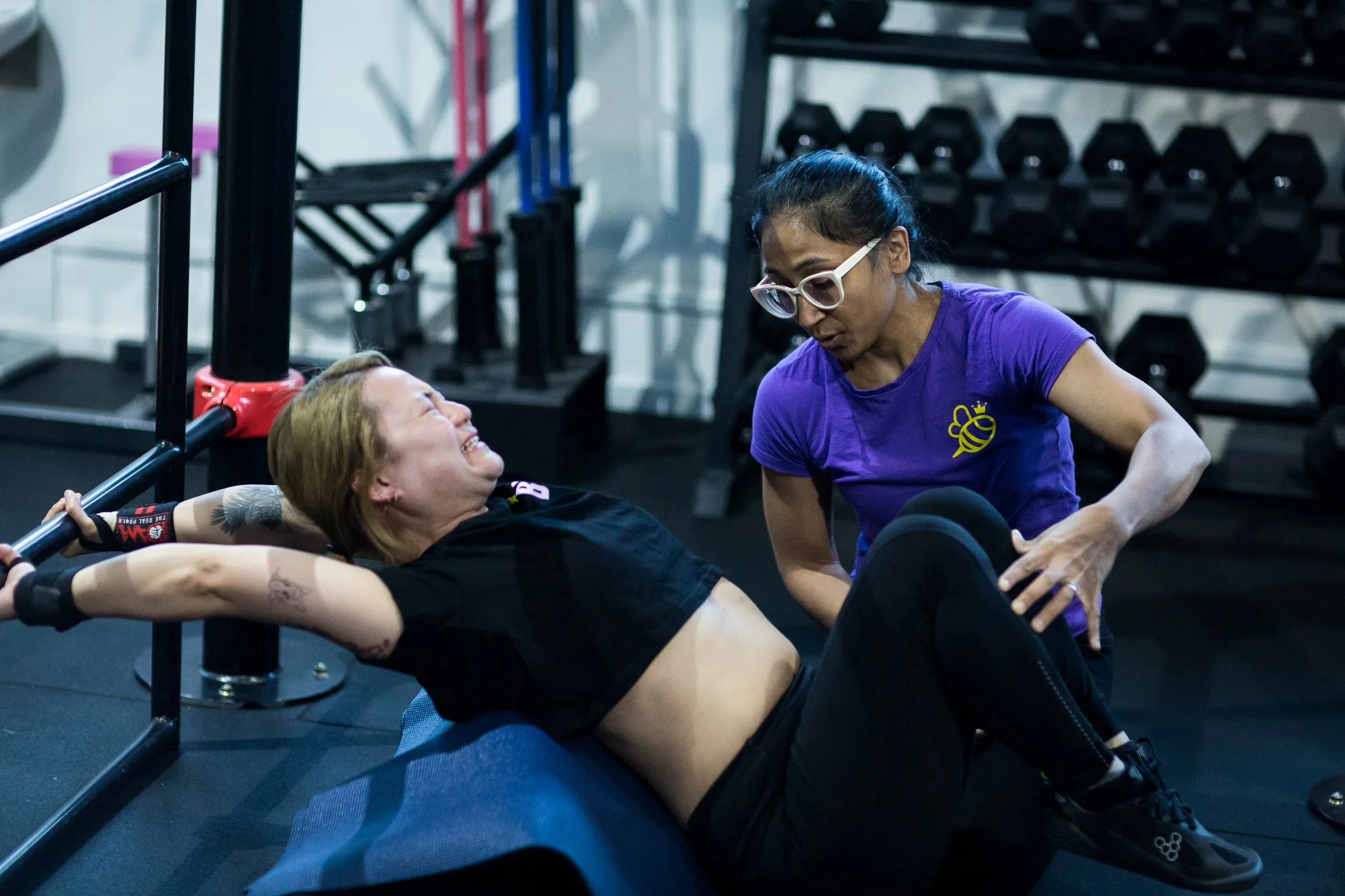 one woman coaching another in a gym