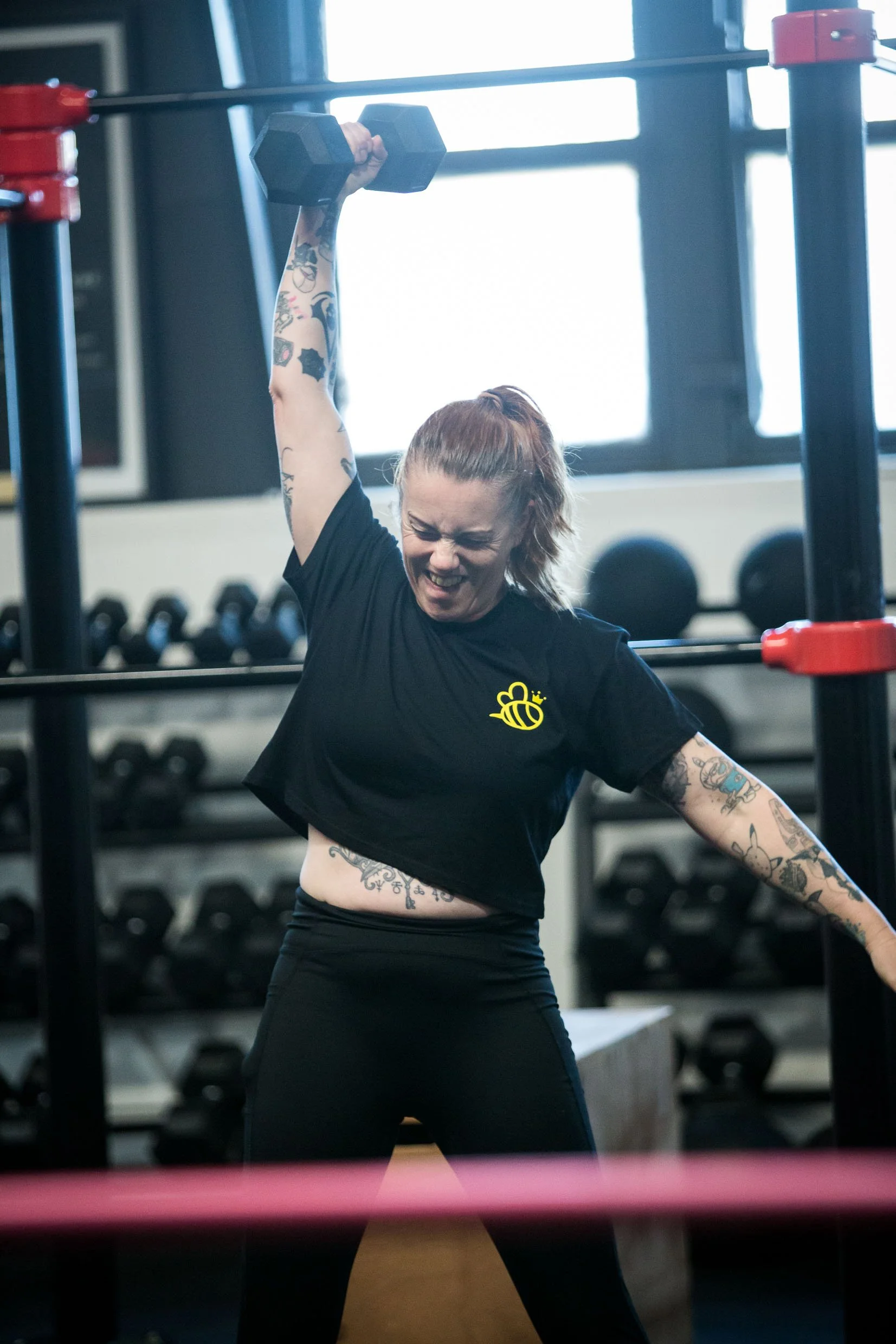 woman lifting a weight overhead