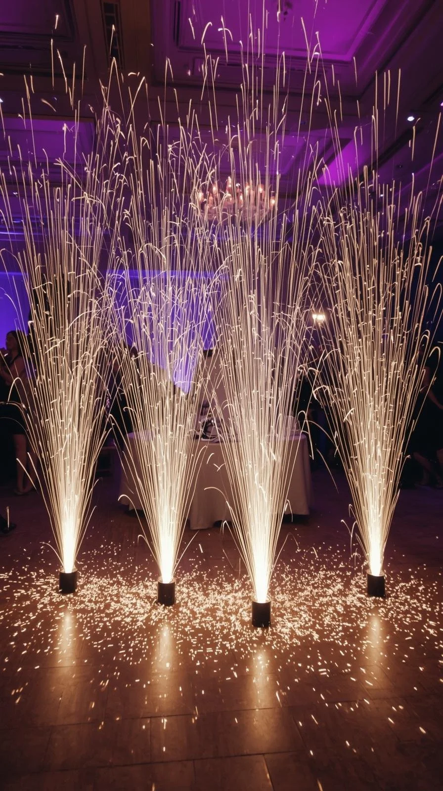 Sparklers create fireworks display at an indoor celebration or event.