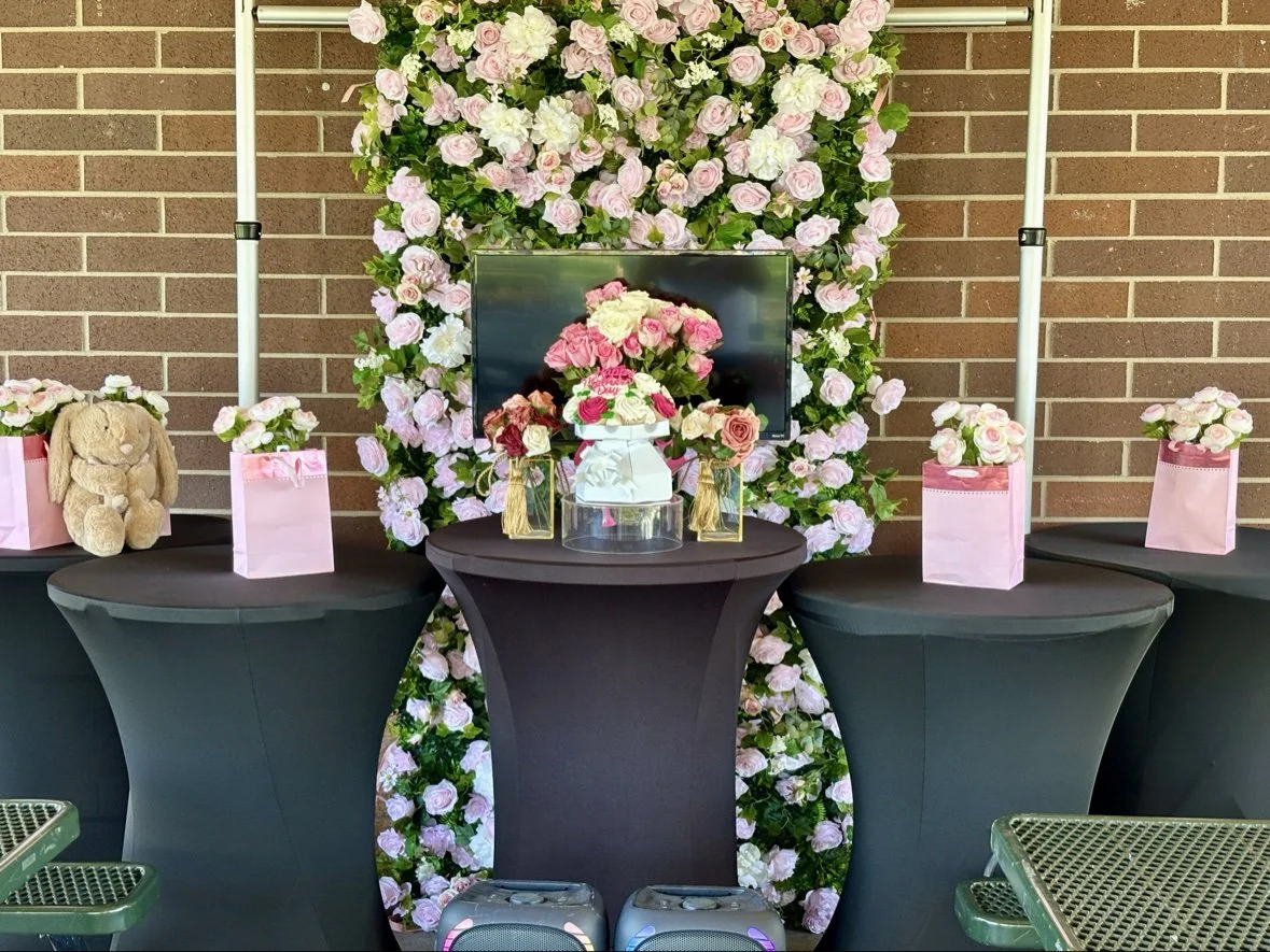 Pink flower wall at a baby shower