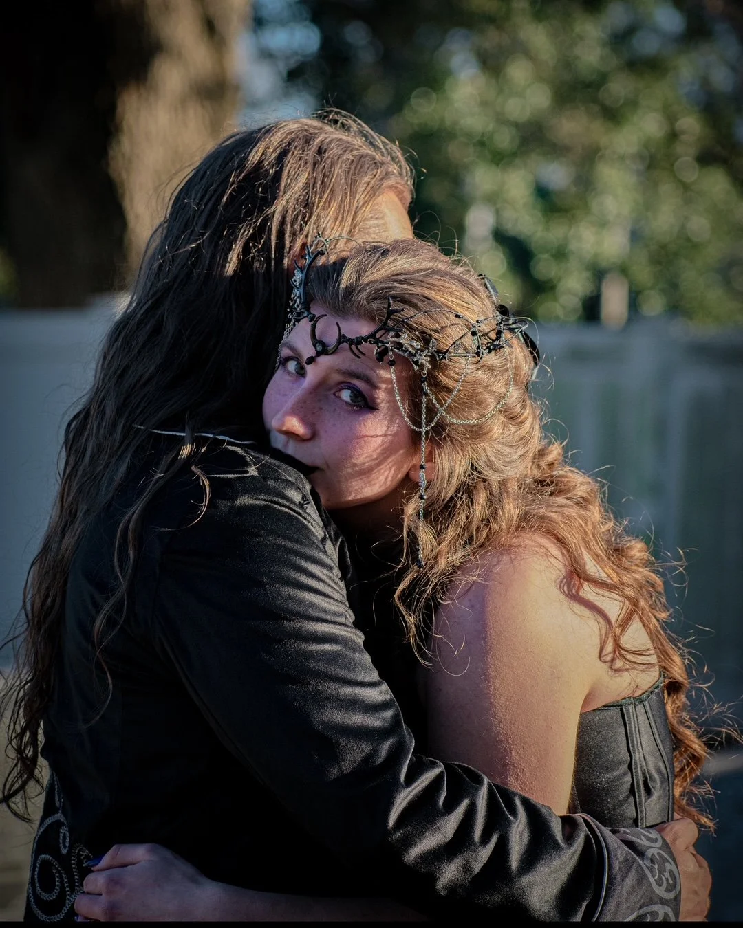 Couple embracing during a creative gothic-inspired portrait photography session.