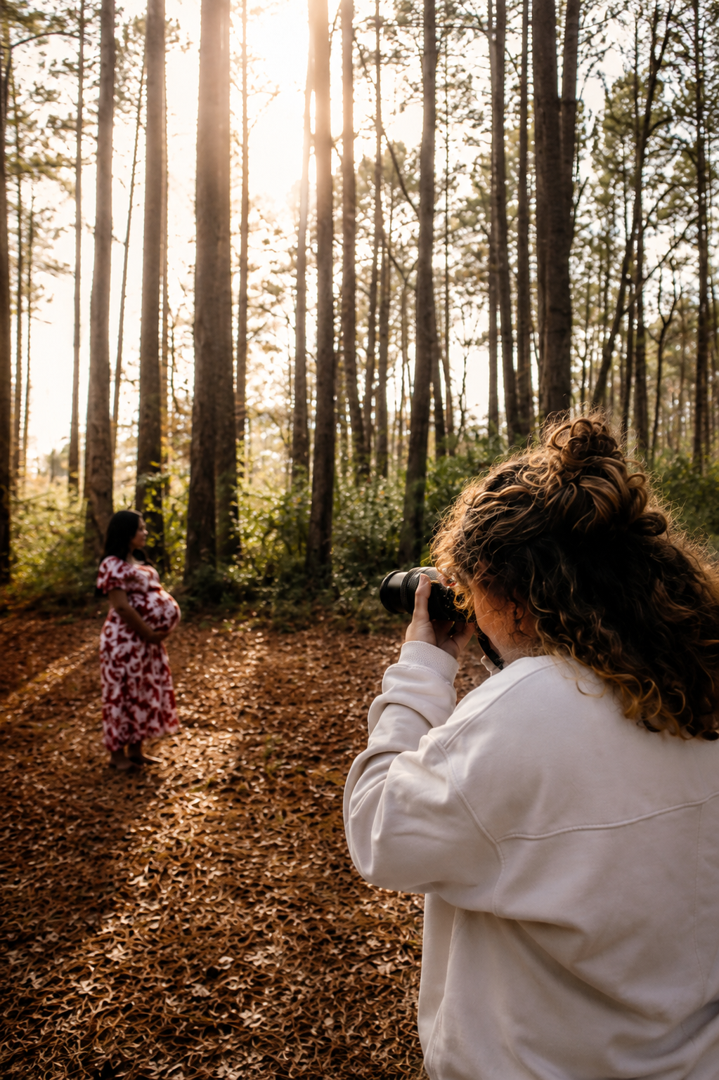 Nevaeh J Photography photographer capturing a maternity portrait session in a wooded outdoor location during golden hour in Jacksonville, North Carolina.