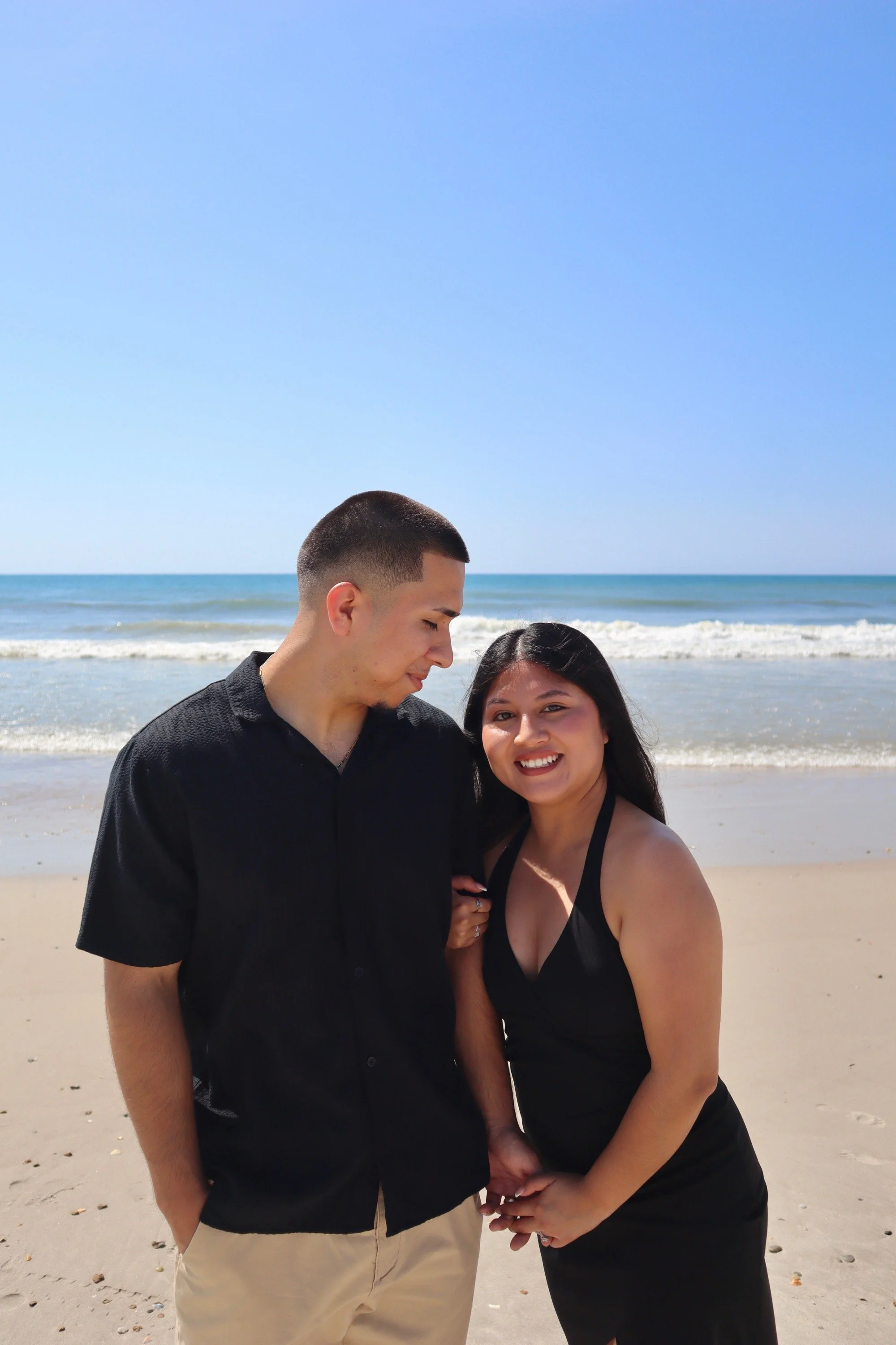 Couple posing together on the beach during a romantic portrait photography session