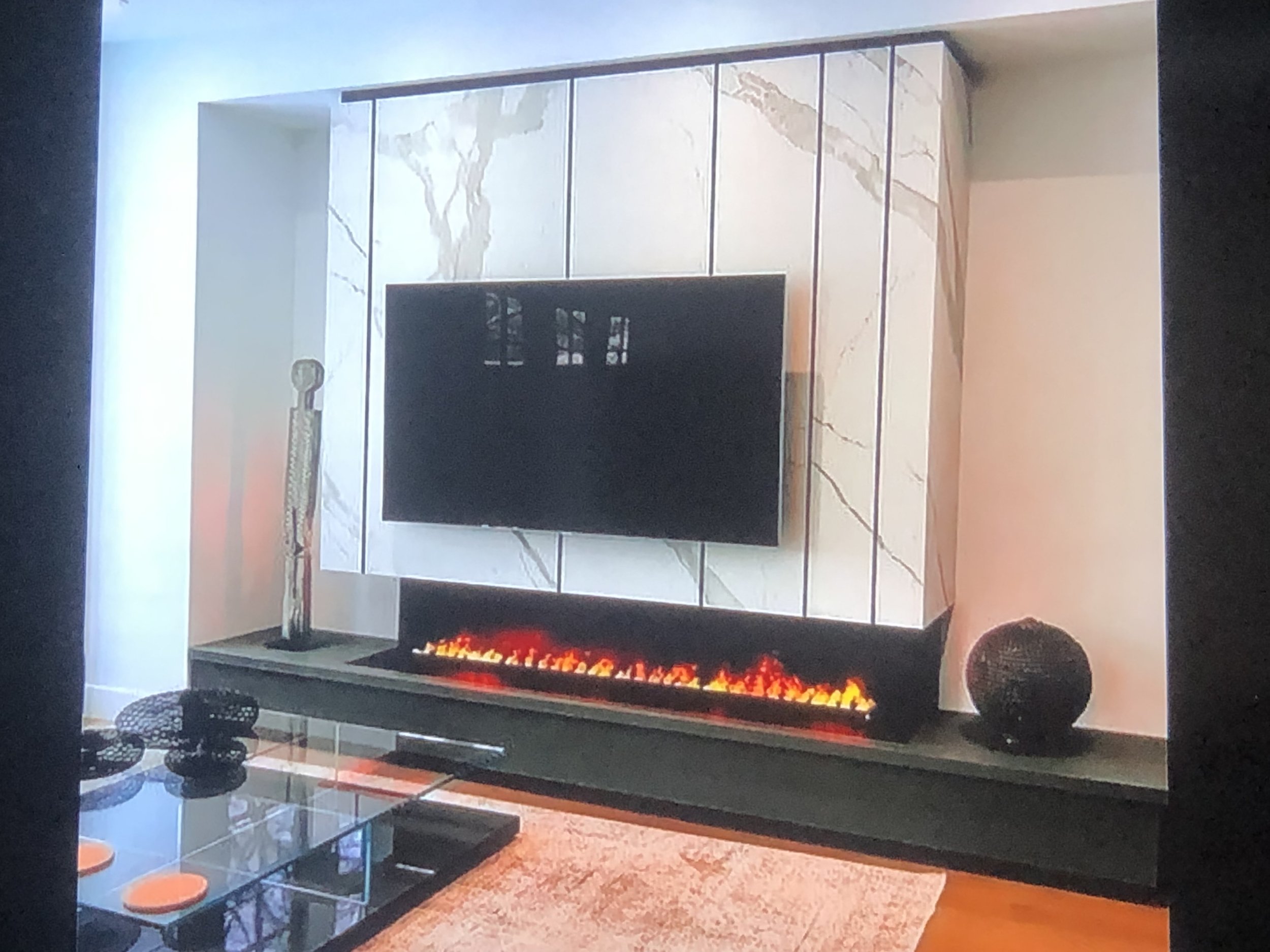 Electric fireplace with a marble surround in a living room.