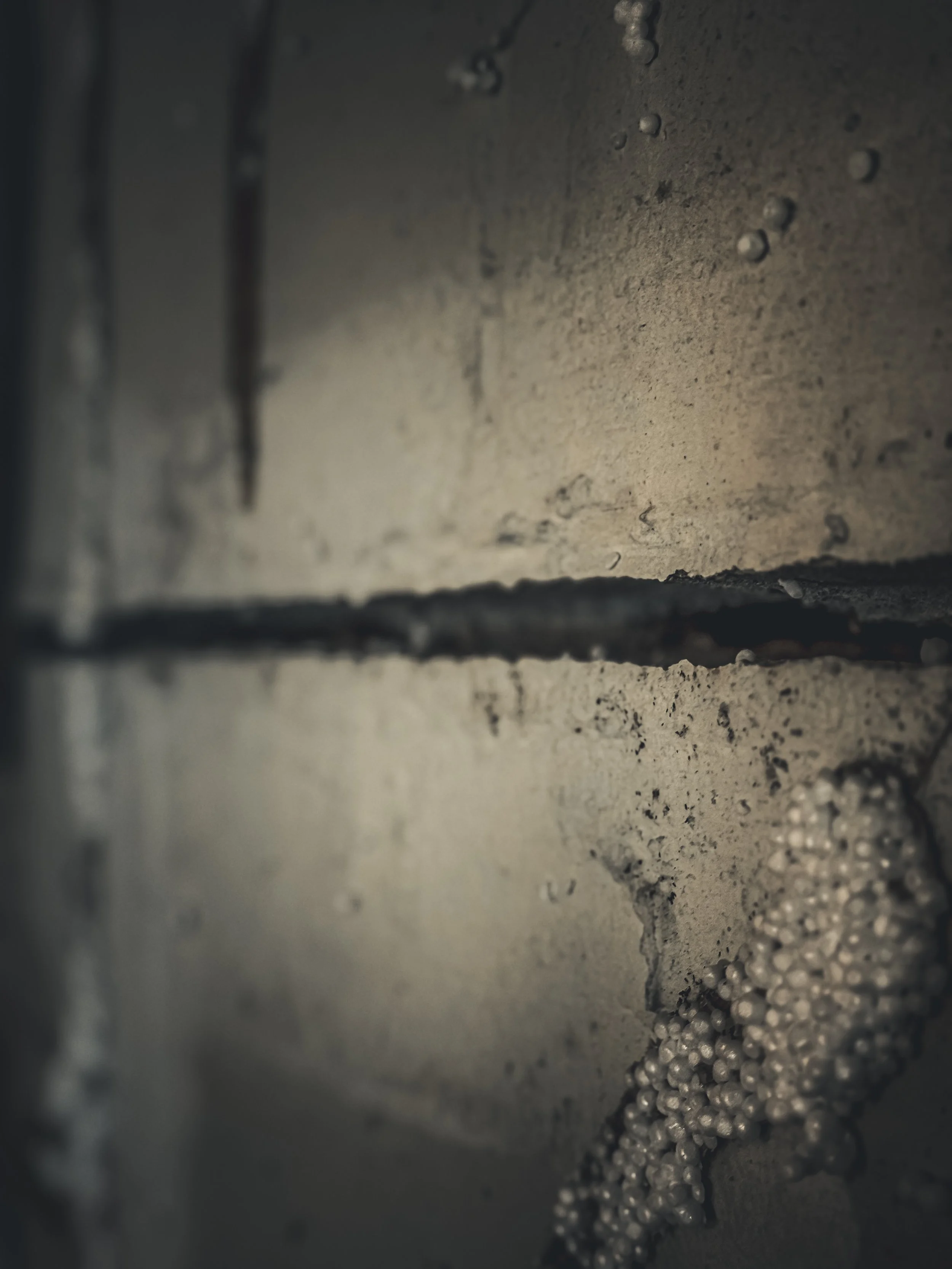 Close-up view of a fractured, bowing foundation wall
