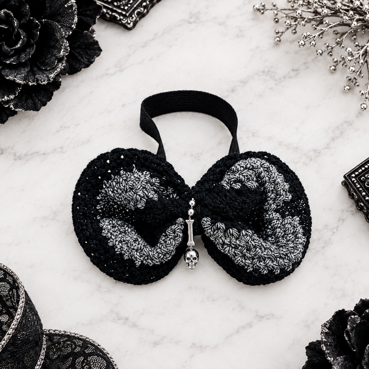   The "Midnight Round 1 " A bold, rounded bowtie in black acrylic knit are accented with shimmering bamboo-blend silver yarn and crowned by a skull pendant. With its distinctive rounded silhouette and refined monochromatic palette, this is more than 