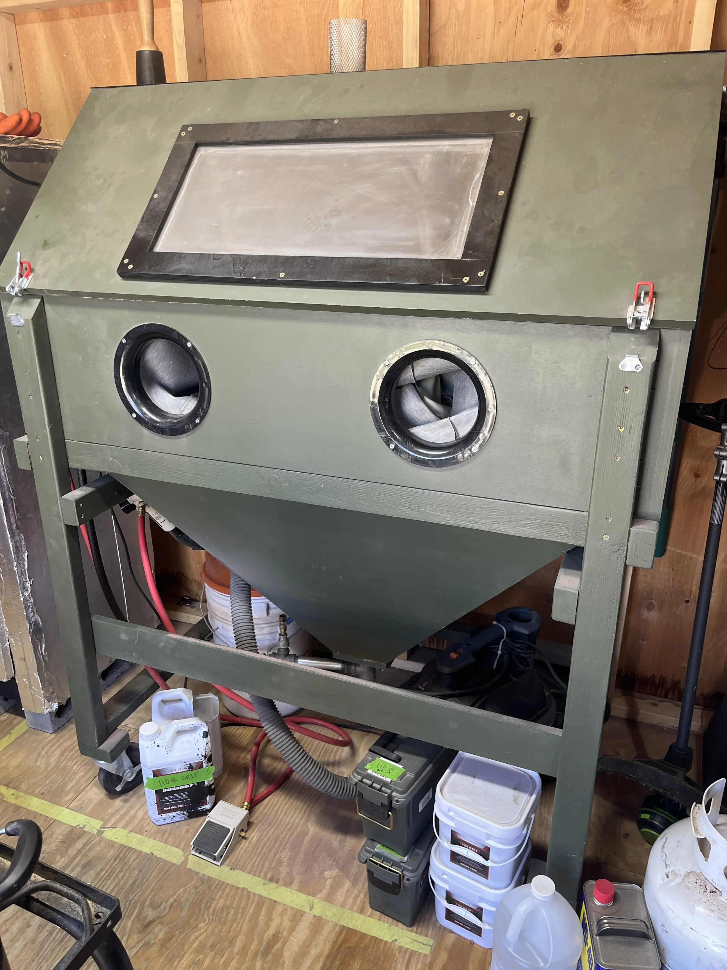 A sandblast cabinet with associated media and materials