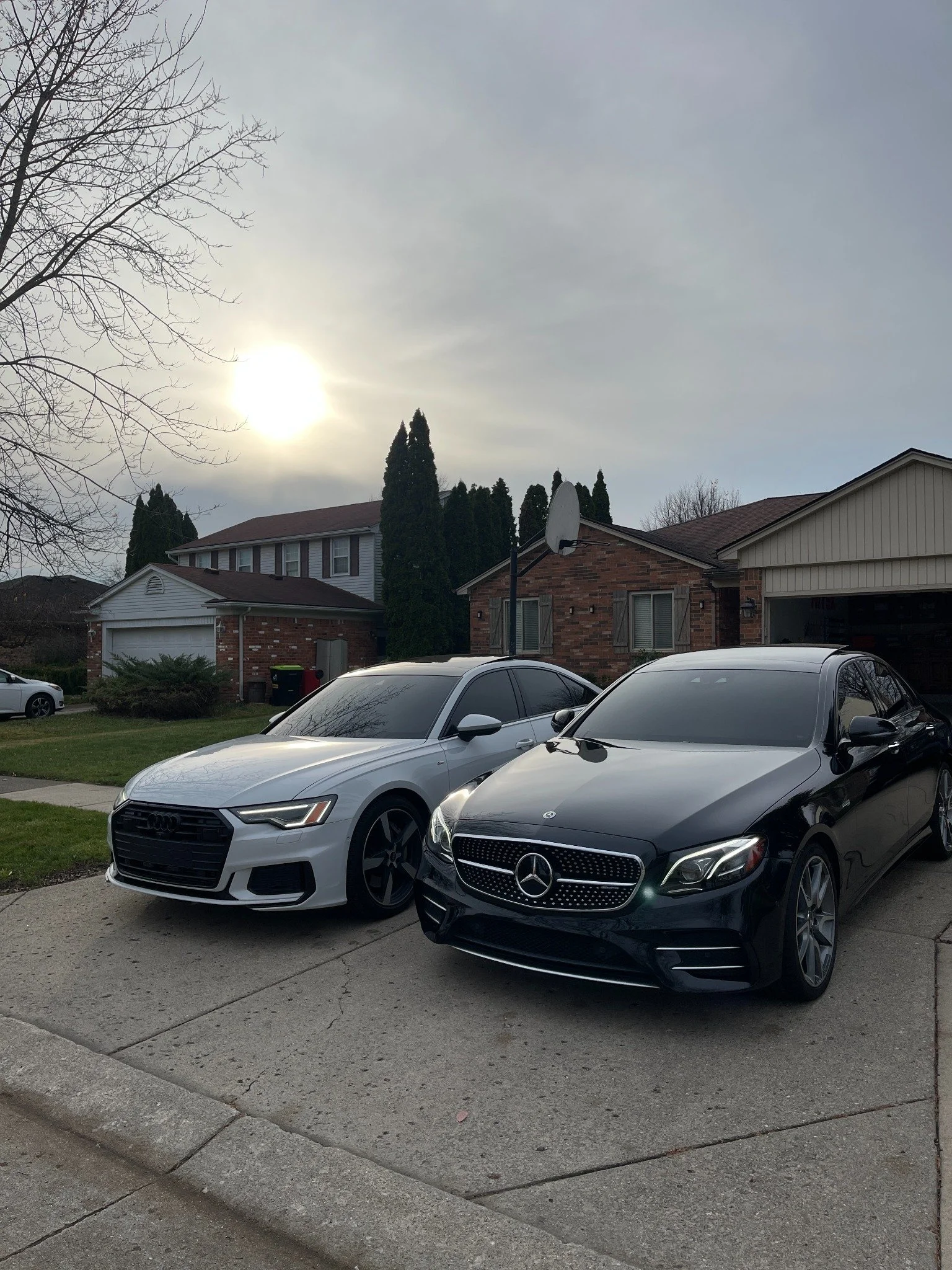 White Audi and black Mercedes-Benz with new window tint by Expert Auto Spa, serving Macomb, Shelby Twp, Port Huron, Pontiac, Birmingham and Bloomfield. Mobile window tinting, auto detailing and ceramic coating in Metro Detroit.