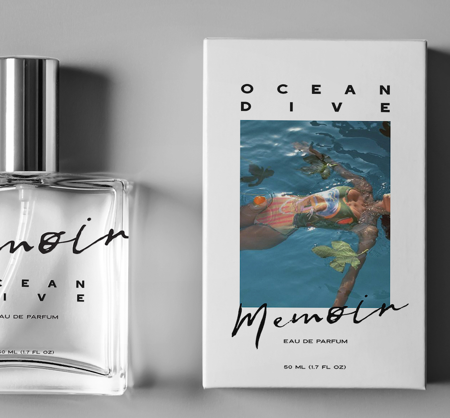 A perfume bottle and box with the label "Ocean Memory Eau de Parfum"; the box features an image of a person floating in a swimming pool surrounded by leaves.