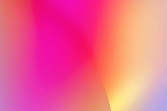 Abstract colorful gradient background with pink, purple, yellow, and orange hues.
