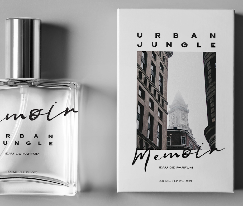 A bottle of perfume labeled 'Urban Jungle Memoir' next to its packaging box with a cityscape image and the text 'Urban Jungle Memoir Eau de Parfum'.