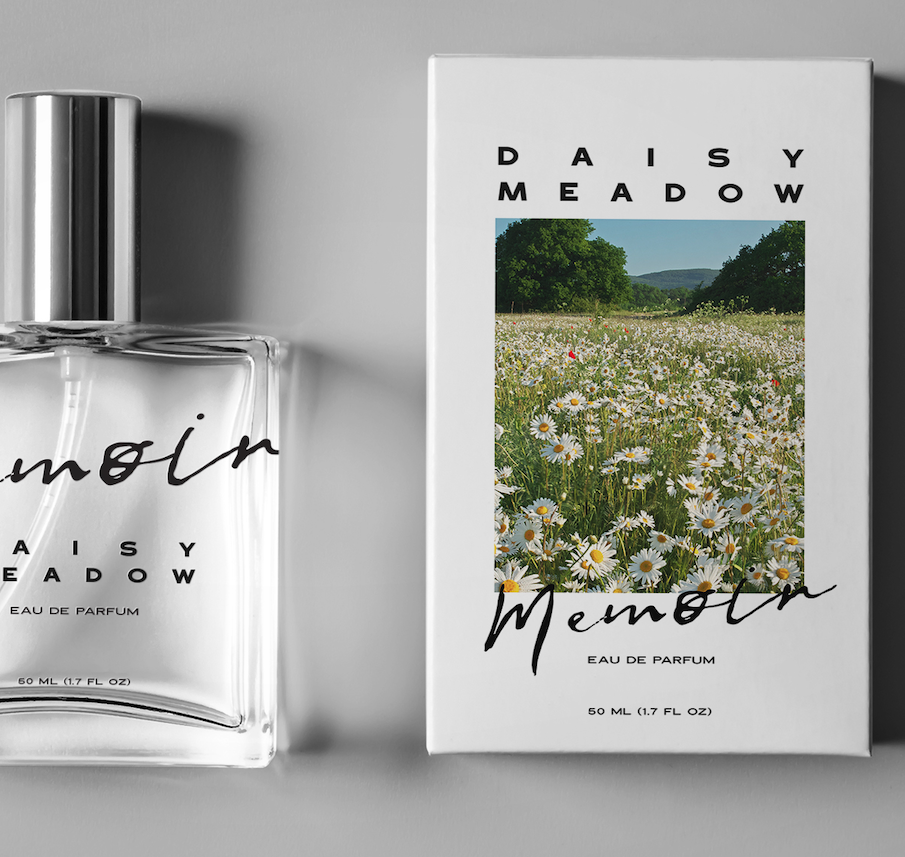 A bottle of Daisy Meadow perfume next to its packaging box, which features a photograph of a meadow with daisies and trees.