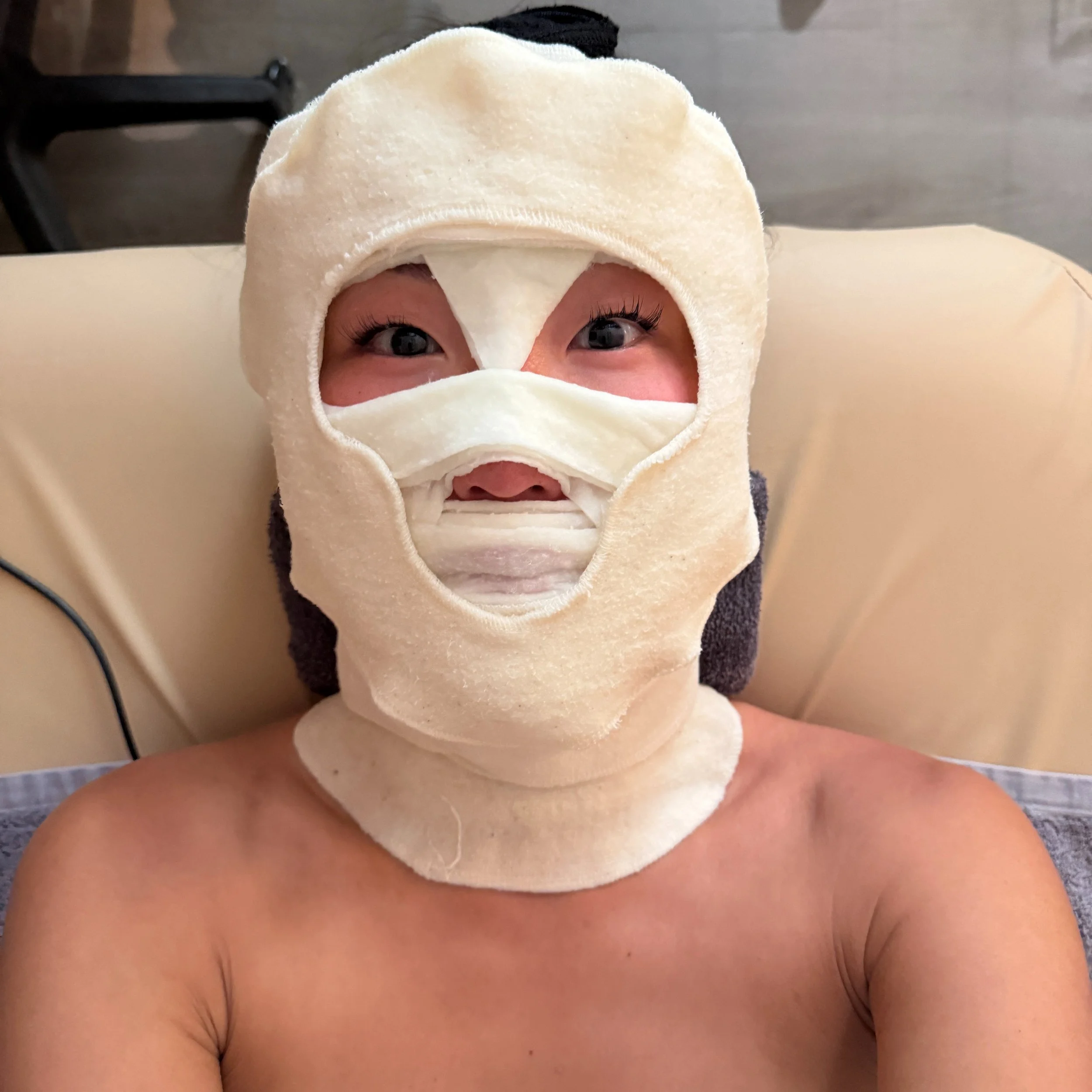 WHAT THE HELL IS THIS?! 😳

Well, let me explain.

This is the final&mdash;and probably most recognizable&mdash;step of our Signature iDerm Facial.

After extractions, we wrap the face in cotton and specially cut fabric saturated with our proprietary