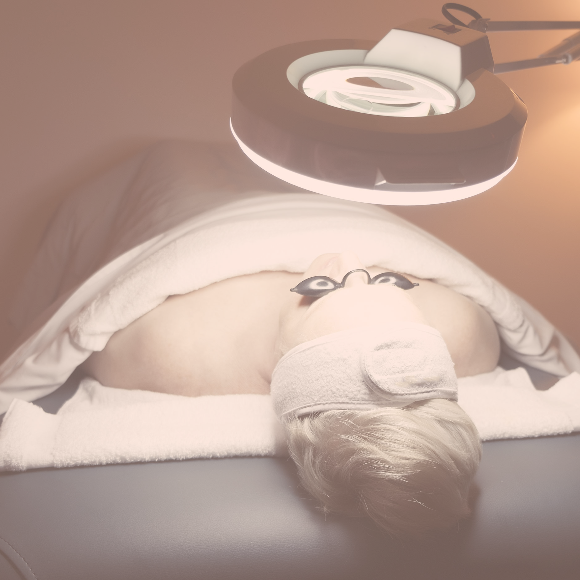 Close-up of a dental dental curing light with a white flexible arm, white body, and a light-emitting diode head.