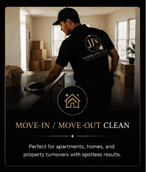 A man wearing a black cap and shirt with the company logo JJ's where it's clean inside a kitchen, preparing for a move-in or move-out cleaning service, with cardboard boxes in the background.