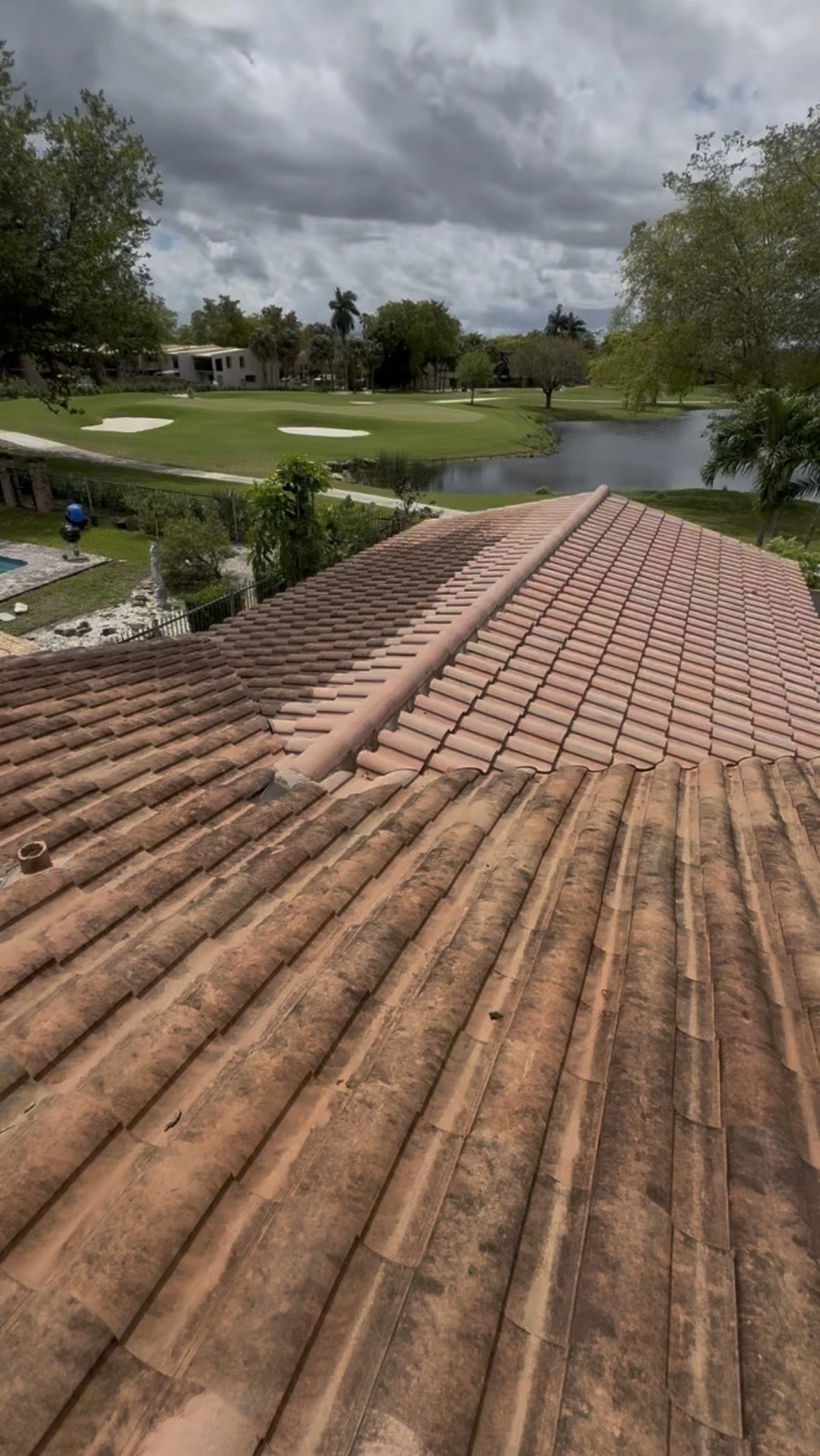 Tile roof soft washing and roof cleaning for a residential property in South Florida.
