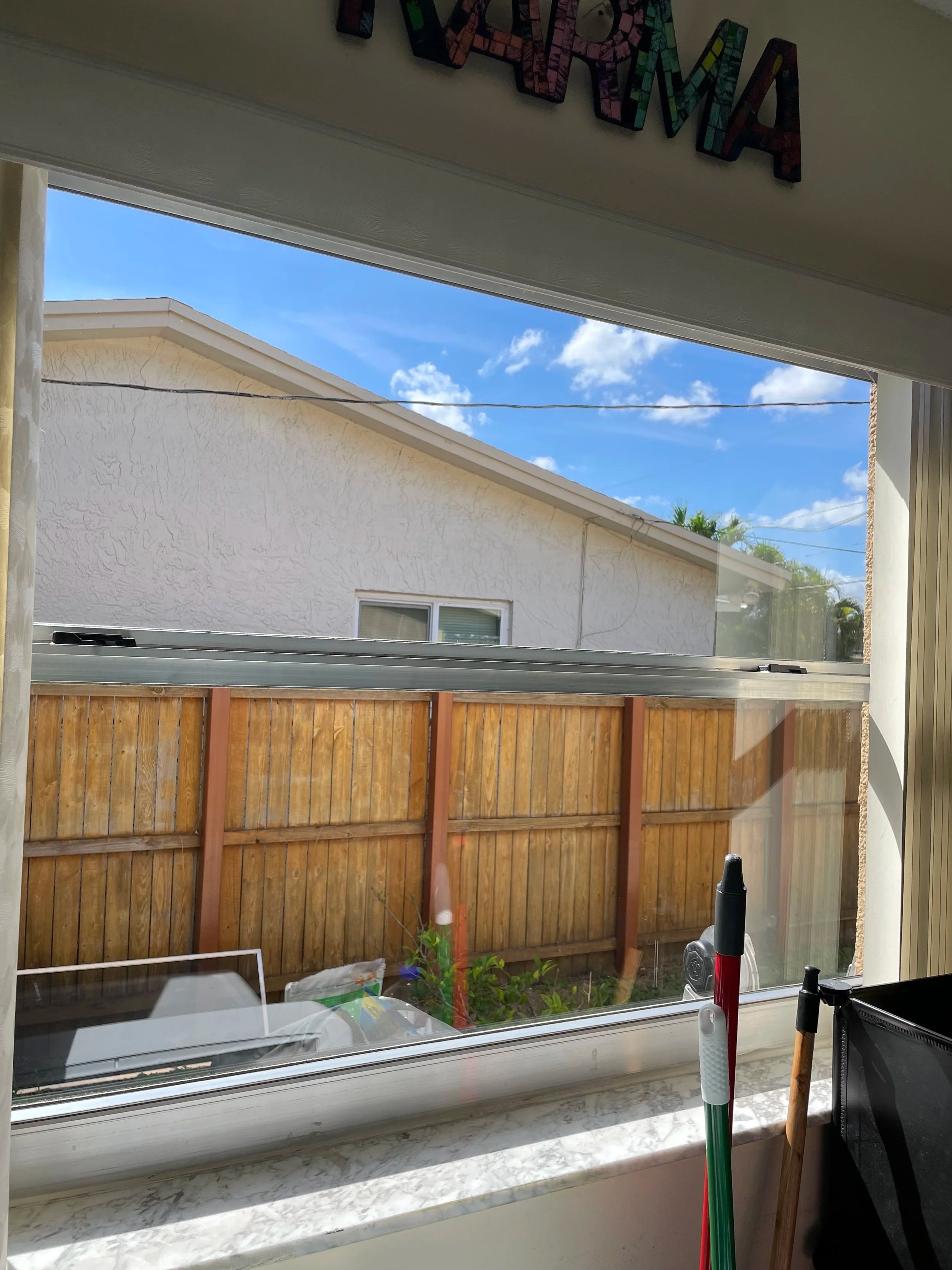 After professional window cleaning showing a clean window at a South Florida home.