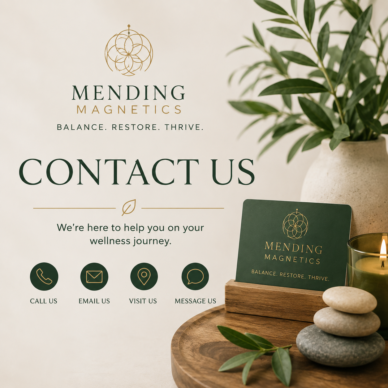 A wellness business contact information display featuring a large sign with the company's logo, name 'Mending Magnetics,' and tagline 'Balance. Restore. Thrive.' A smaller sign with the same branding is on a wooden stand surrounded by rocks, candle, and green plant leaves. Four icons below text represent contact options: call, email, visit, and message.