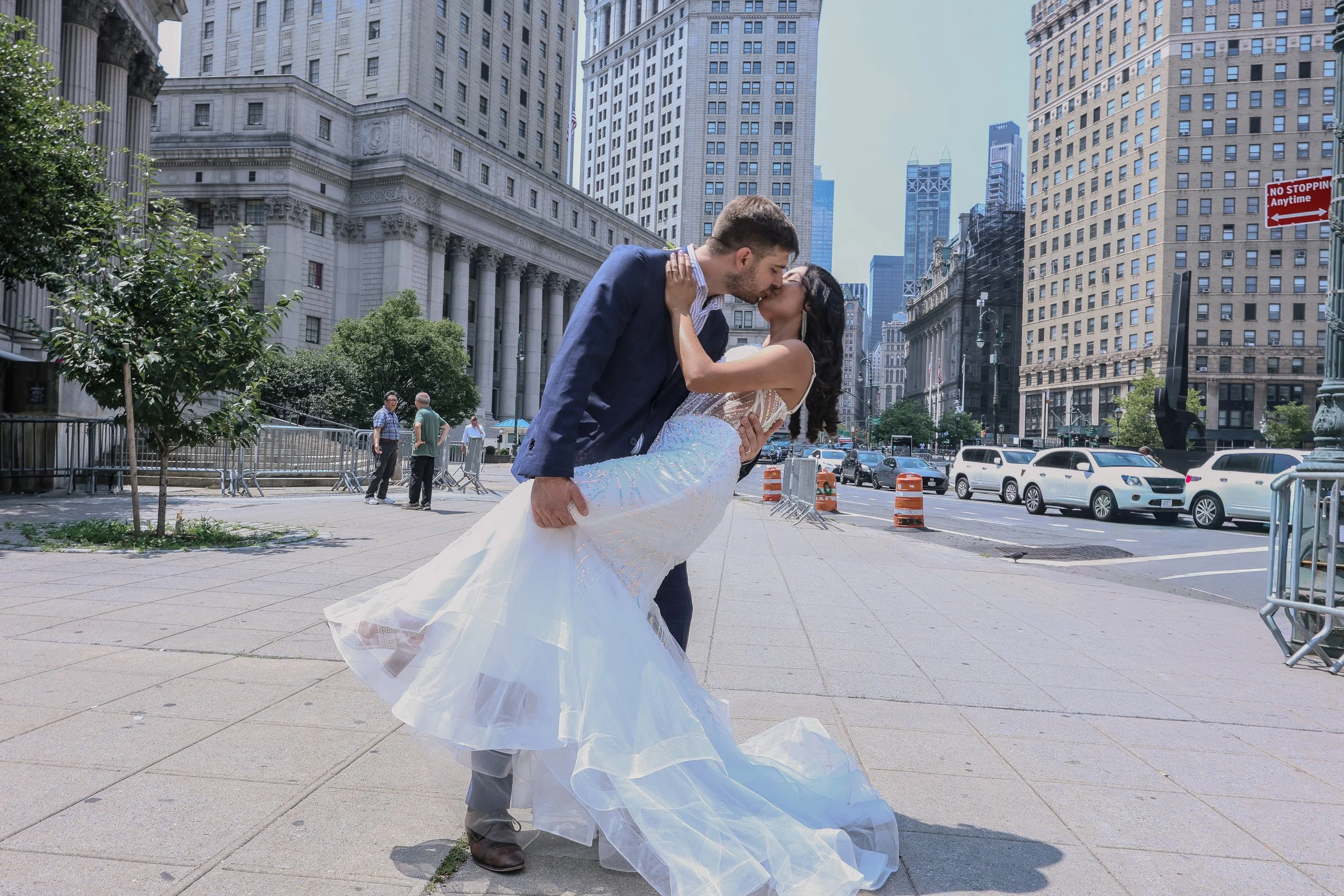 Newlyweds sharing a candid kiss during an urban elopement photo shoot in New York City