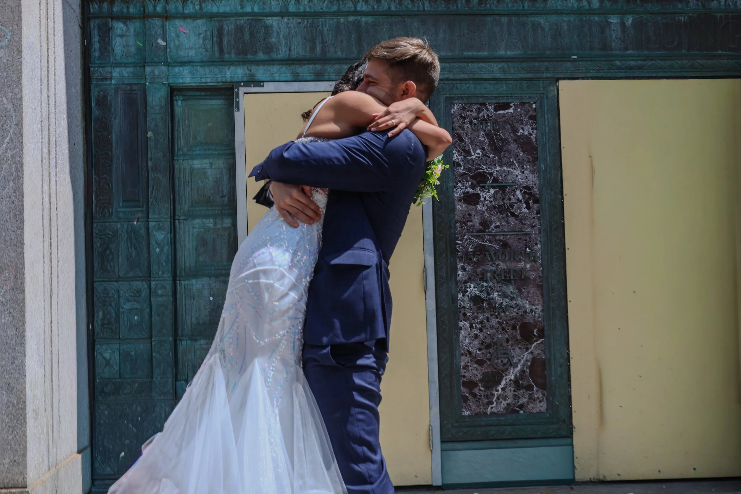 Bride and groom embracing in a romantic intimate portrait taken during a New Jersey city hall wedding
