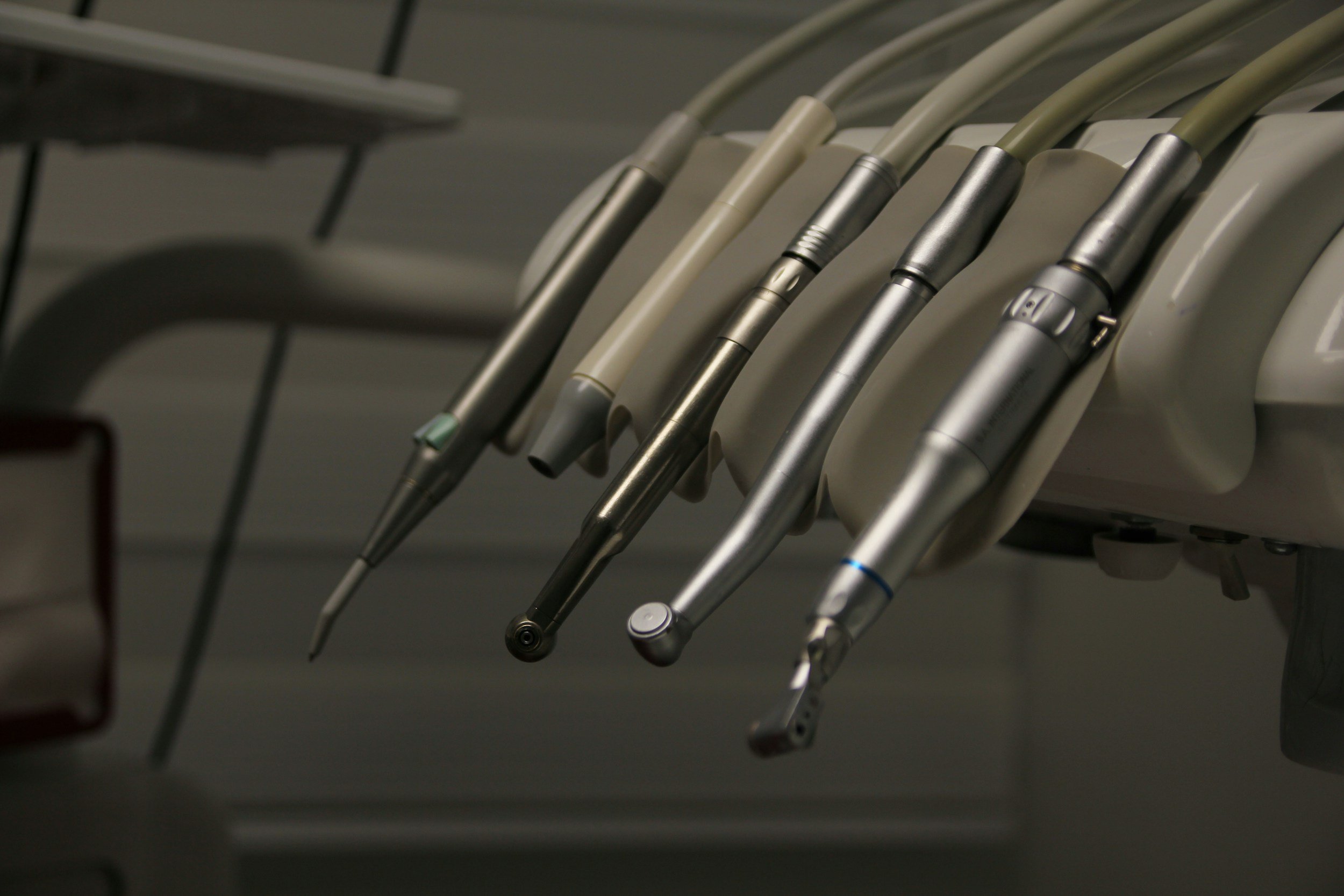A row of dental handpieces (dental drill tools) hanging on a dental unit in a dental office at Legacy Family Dental
