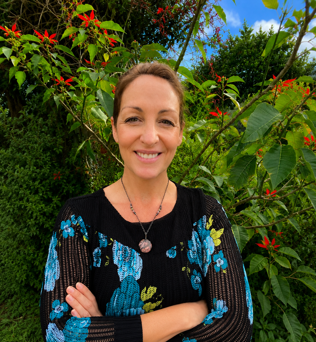 Sarah Humble, counsellor and founder of Still Heart Counselling, smiling outdoors in a natural garden setting.
