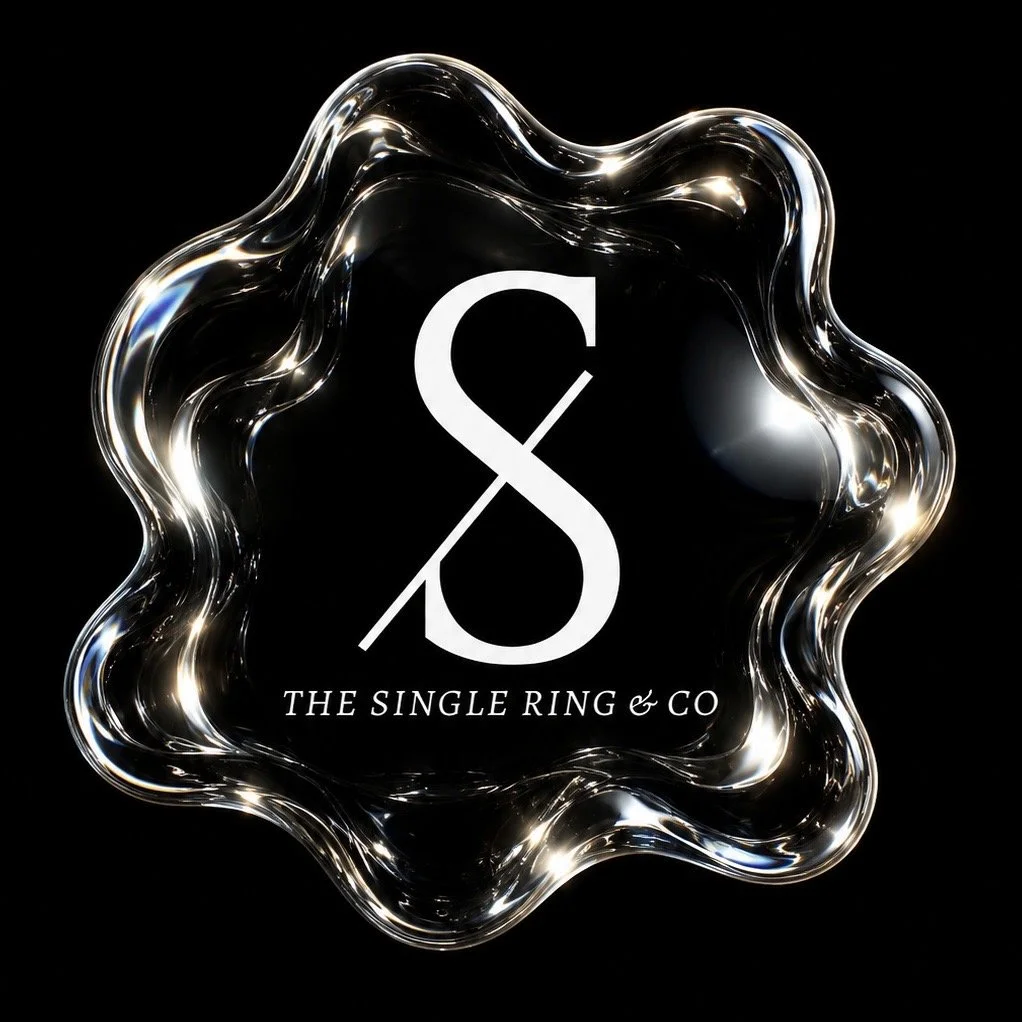 Logo for The Single Ring & Co company, featuring a stylized 'S' with a diagonal line through it, surrounded by a shiny, irregular metallic border on a black background.
