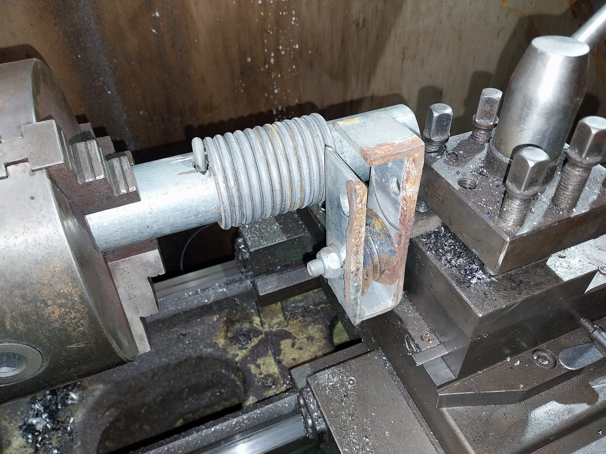 Close-up view of a metal mechanical device or machine component creating curtain rings.