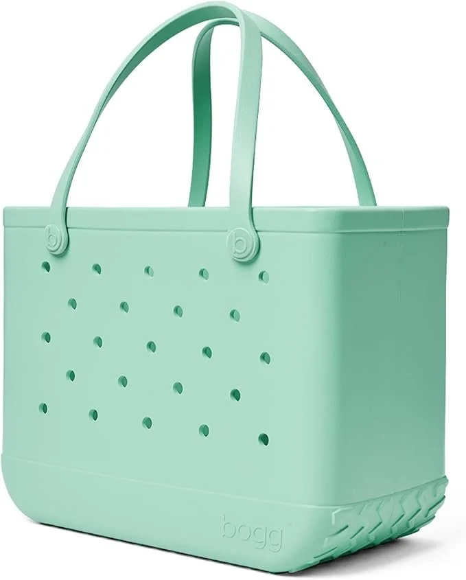 Mint green silicone tote bag with small circular holes and handles.