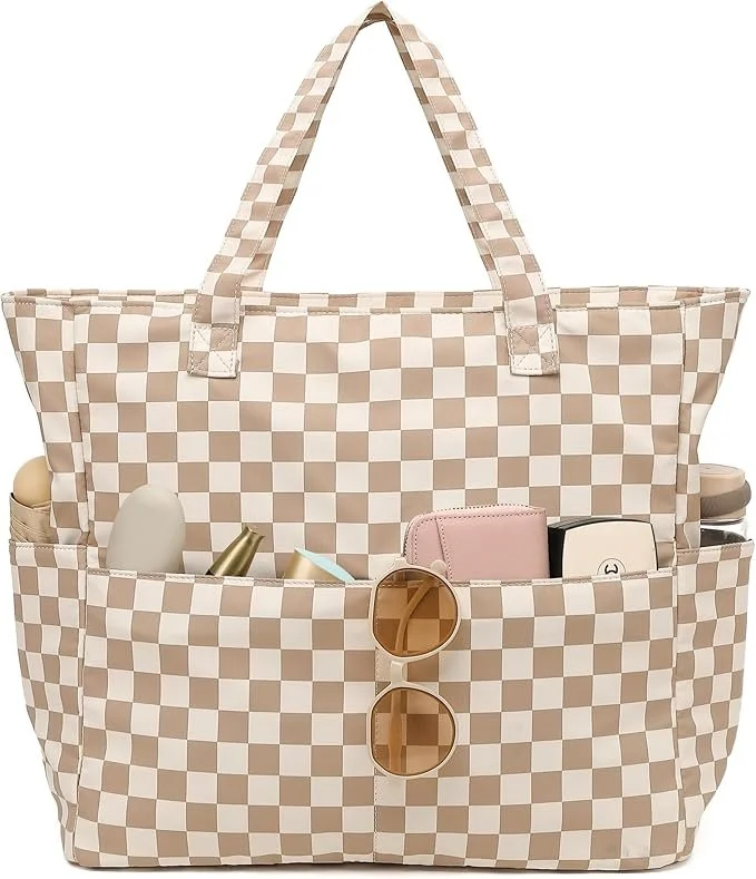 Beige and white checkered tote bag with sunglasses hanging from front pocket, containing various personal items like a pink wallet, sunglasses, and small bottles.