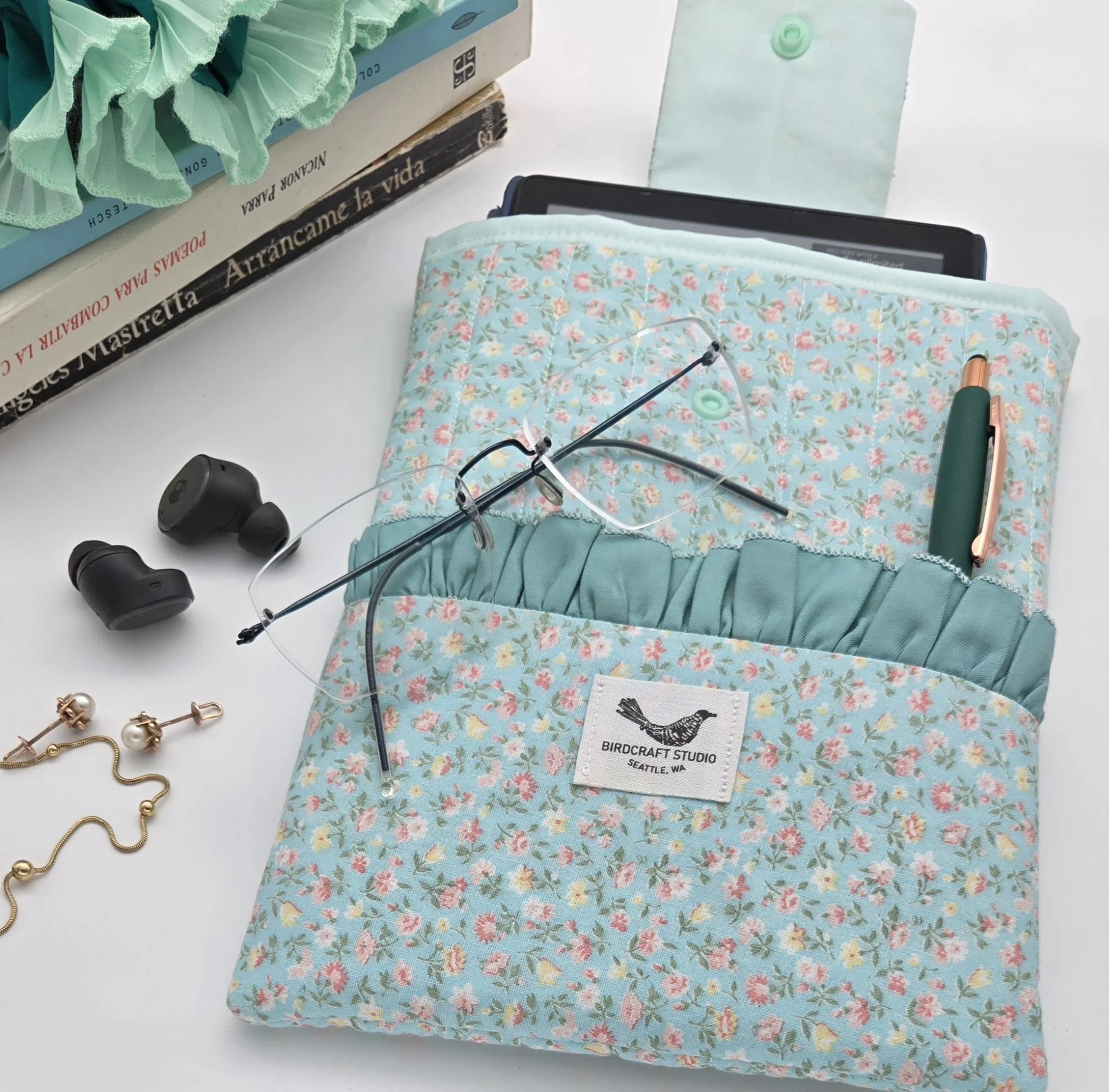Upcycled floral Kindle sleeve by Birdcraft Studio, sewn from reclaimed fabric as a protective e-reader cover.