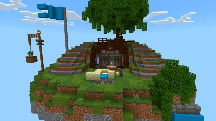 Minecraft floating island with a large tree, a cave entrance, a blue flag, a water fountain, and a player character standing nearby.
