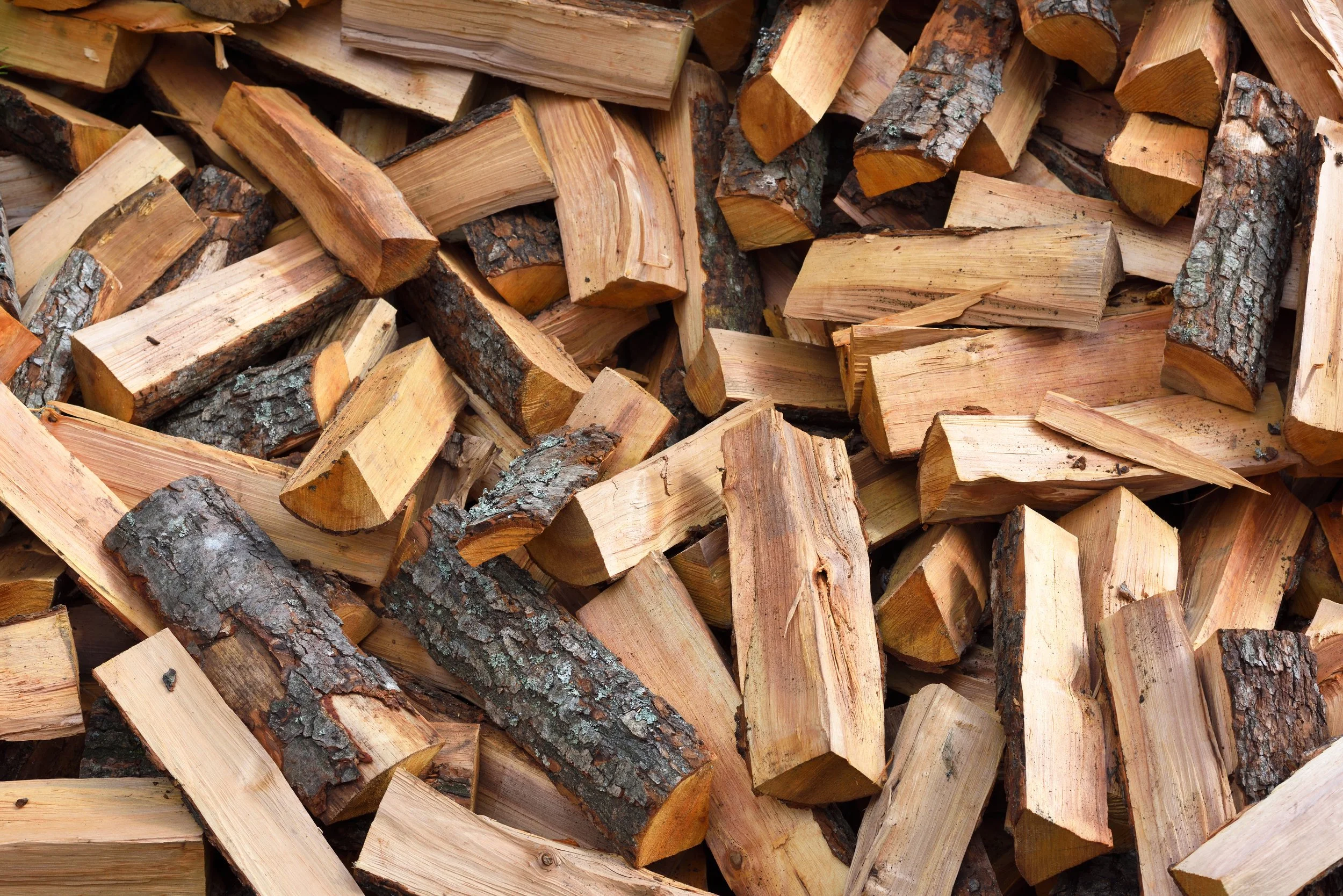 Pile of chopped firewood with bark