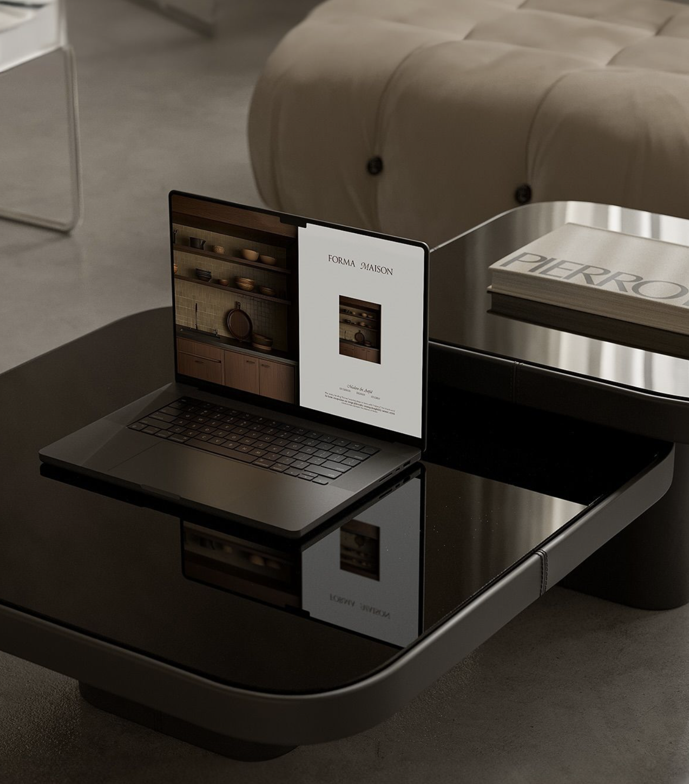 A laptop on a side table displaying a kitchen interior design page, with a beige cushioned bench and a stack of books nearby.