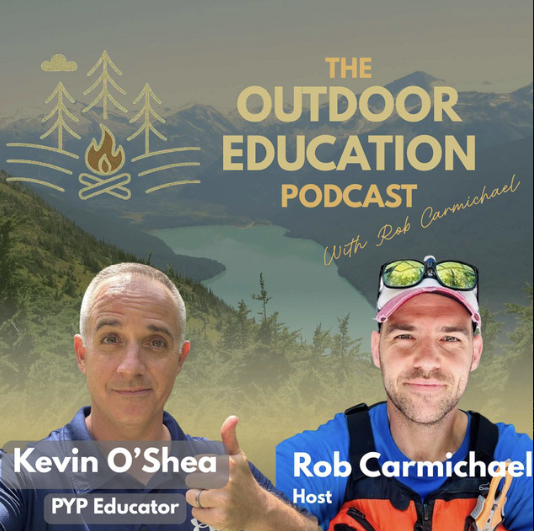 Podcast cover image for The Outdoor Education Podcast with Rob Carmichael, featuring hosts Kevin O'Shea and Rob Carmichael, set against a mountain landscape background including a lake and trees, with a mountain range in the distance.