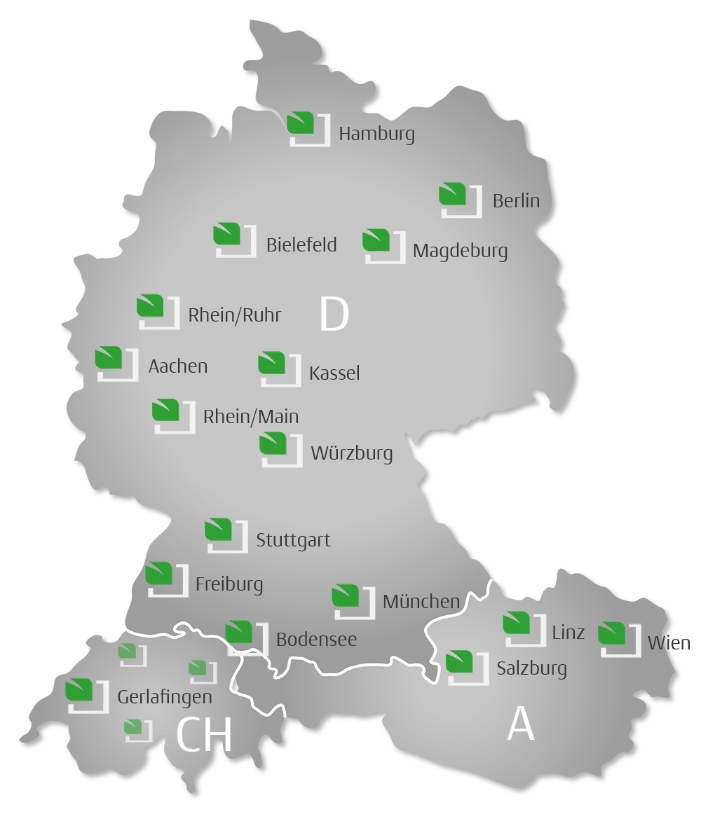 Karte von Deutschland und Österreich mit grünen Symbolen für Standorte in verschiedenen Städten wie Hamburg, Berlin, Bielefeld, Magdeburg, Rhein/Ruhr, Aachen, Kassel, Rhein/Main, Würzburg, Stuttgart, Freiburg, München, Bodensee, Linz, Salzburg, Wien, Gerlafingen.