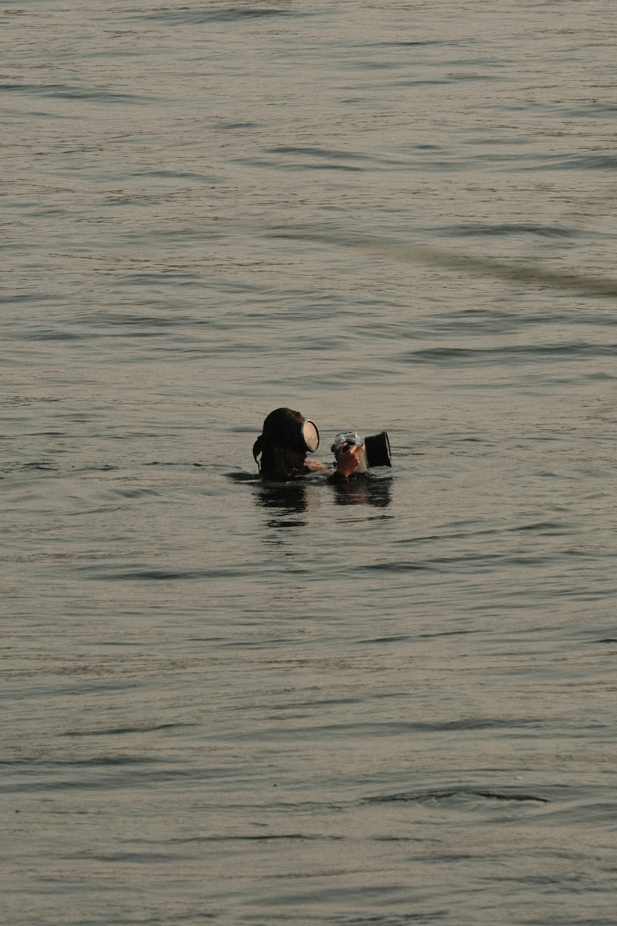 Kate Bryant photographing in the ocean using an underwater housing for surf and documentary photography.