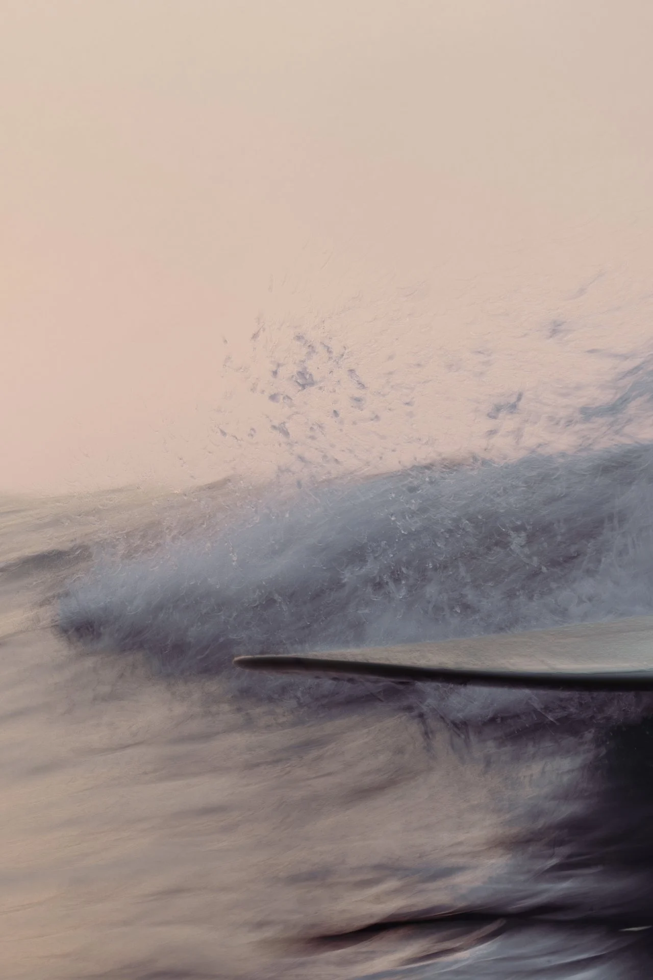 Close-up of a surfboard cutting through a breaking ocean wave.