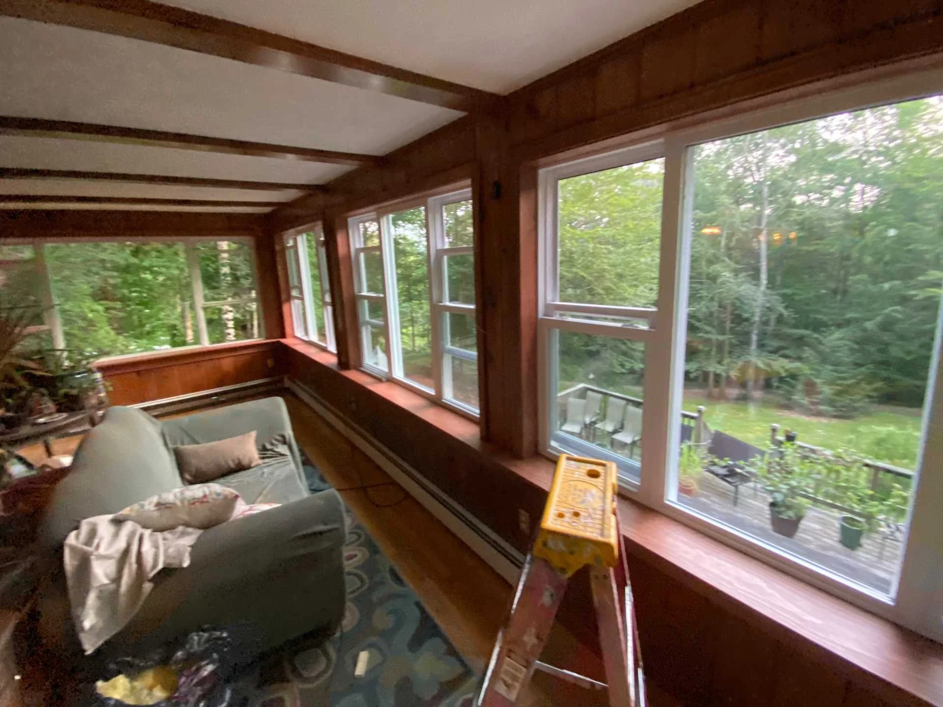 Living room with large new windows and view of green trees outside in Boxborough, MA