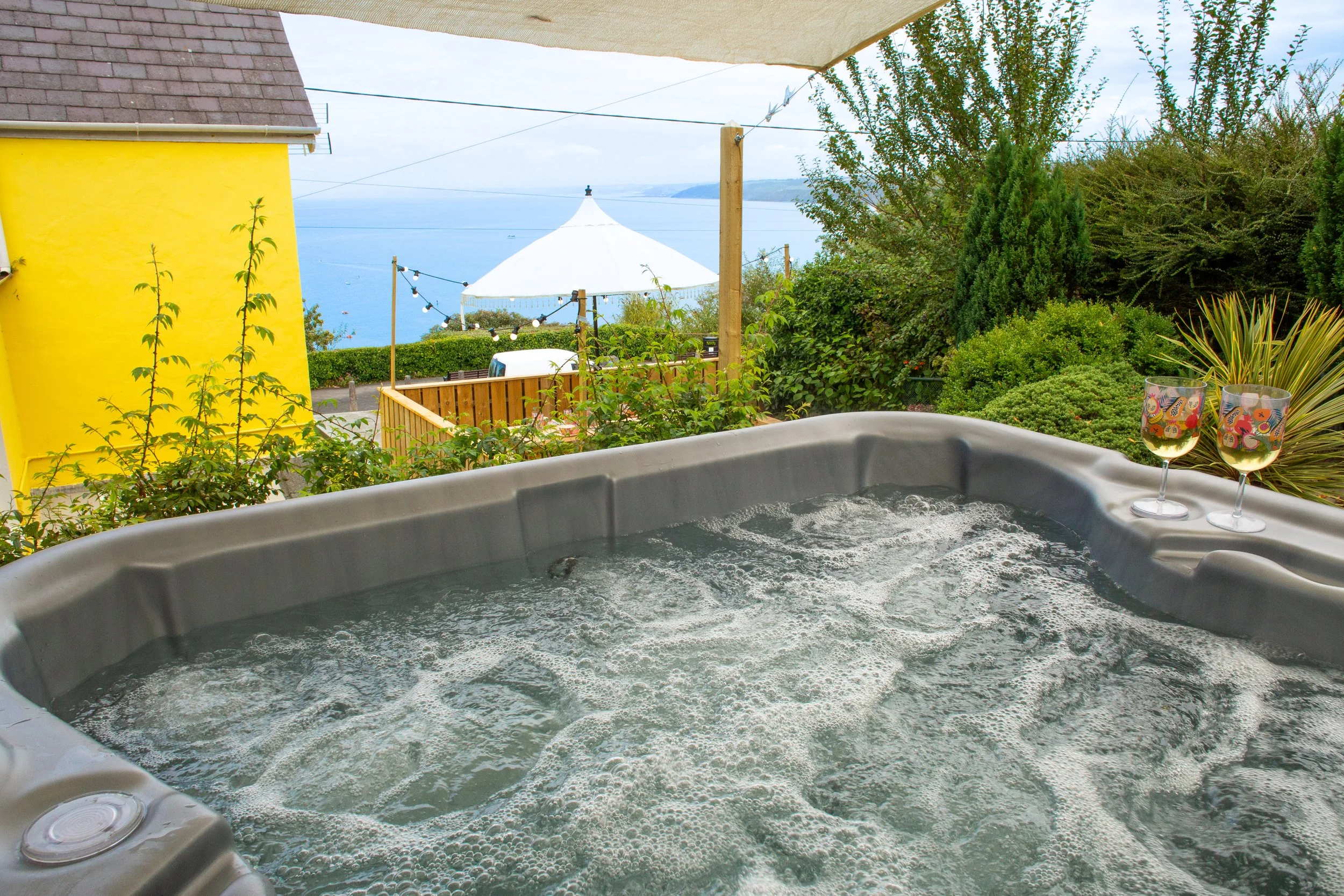 Woman relaxing in a hot tub with her eyes closed and a peaceful expression.