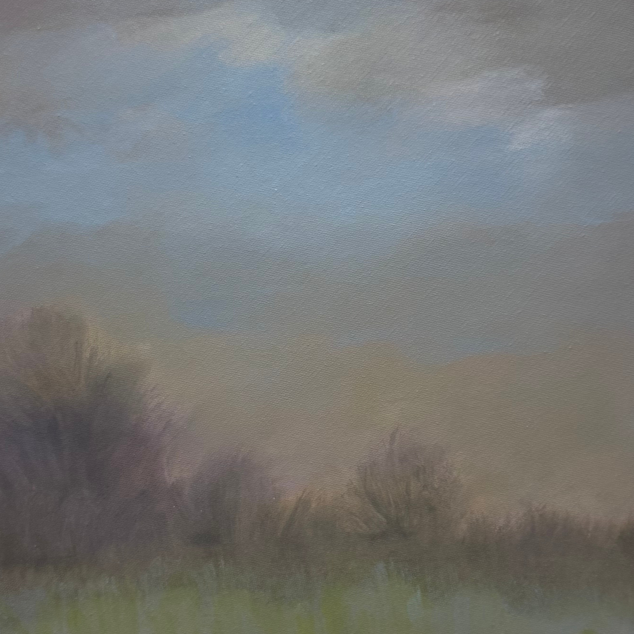 Close-up of a gray textured surface with a faint gradient of light blue and green hues.