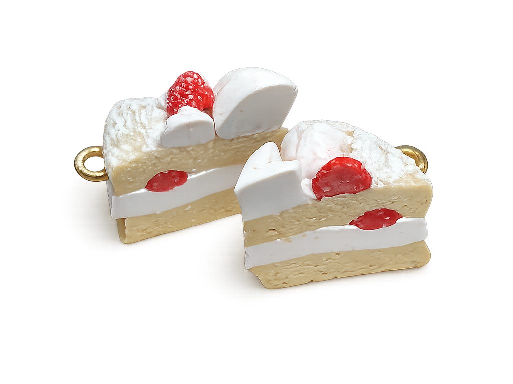 Two slices of strawberry shortcake with whipped cream, strawberries, and a golden ring handle on a black background.
