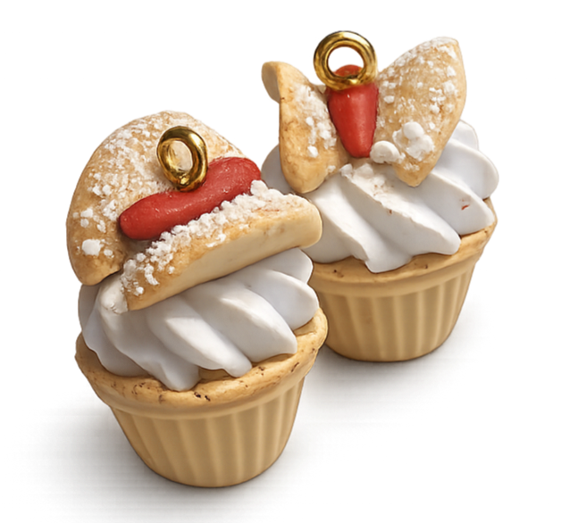 Cupcake with white frosting topped with a decorated cookie resembling a Santa hat, featuring red icing, a gold ring, and powdered sugar.