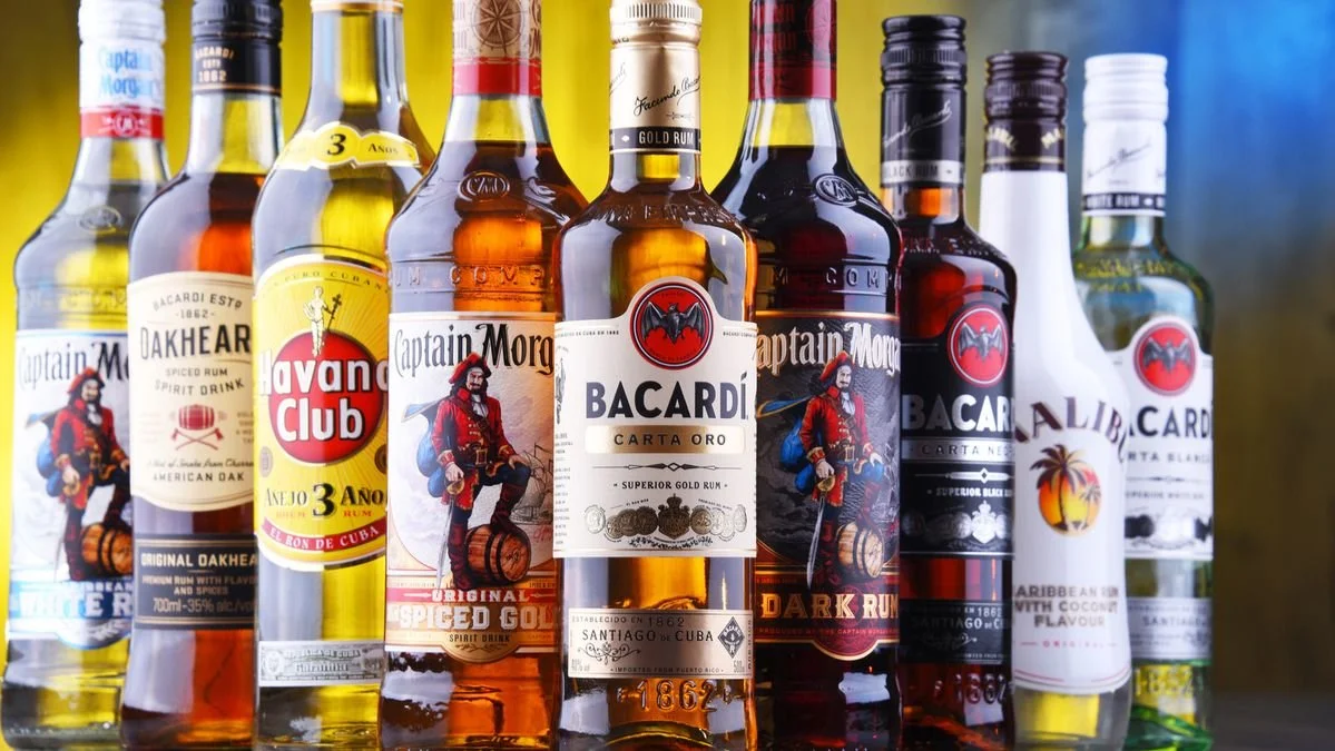 Collection of various Bacardi, Havana Club and other rum bottles on display.