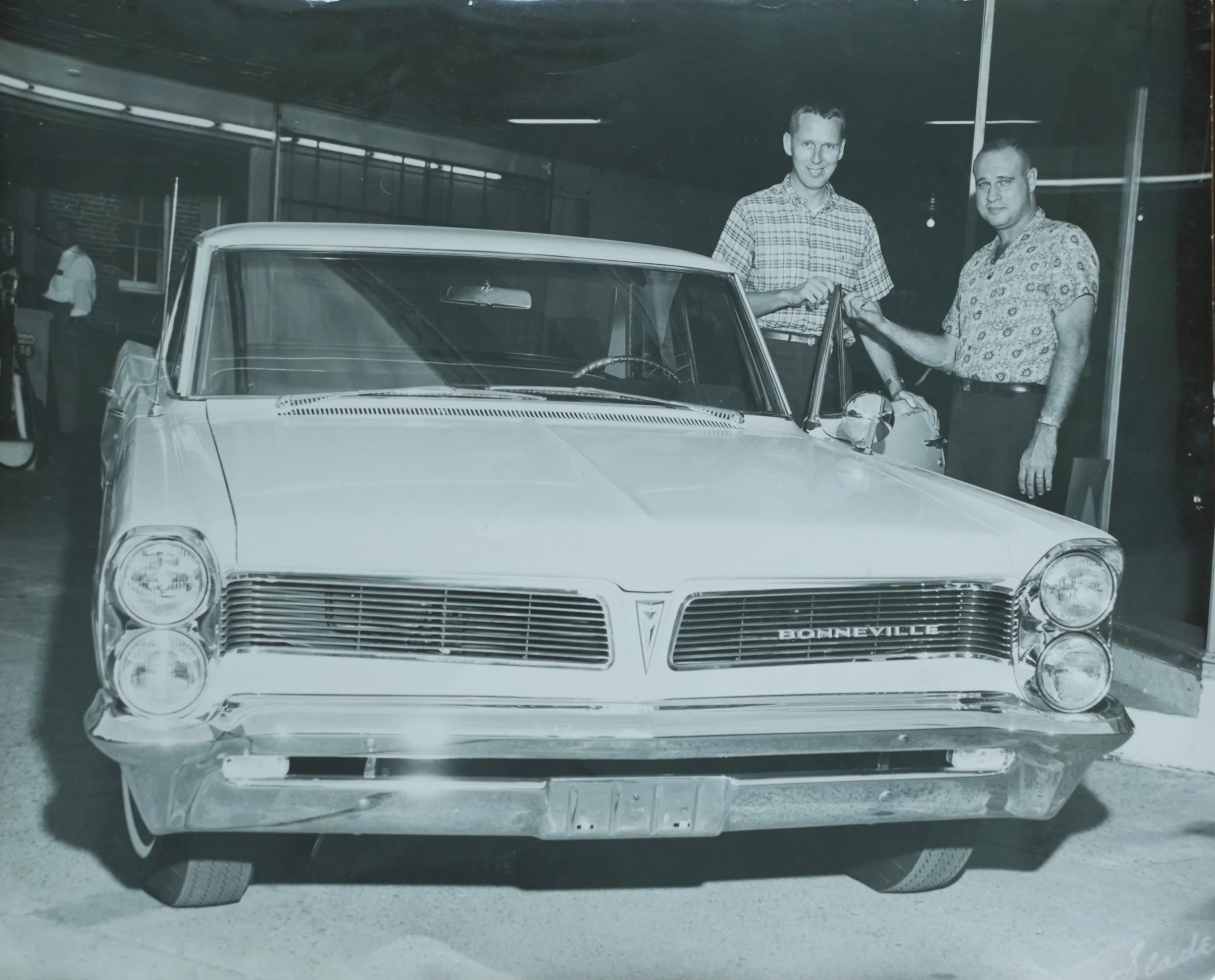 W. Theo Proctor Jr. and a customer with a 1963 Pontiac Bonneville