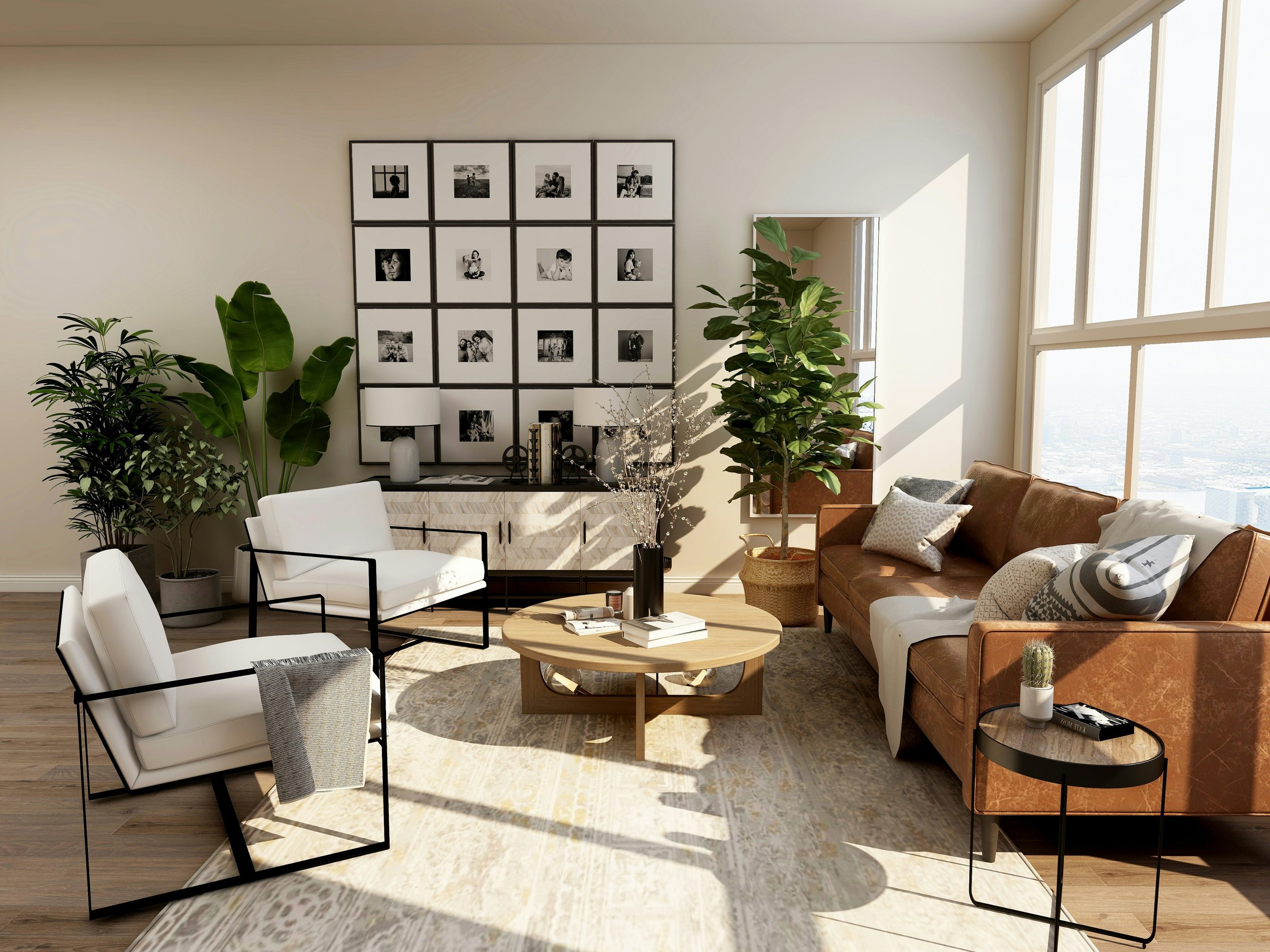A modern living room with beige walls, large windows, and a mix of contemporary furniture. There are several potted plants, a wall display of black-and-white photographs, a white armchair, a brown leather sofa with pillows, a round wooden coffee table with books and decorations, and side tables with lamps. Sunlight streams through the windows, illuminating the space.